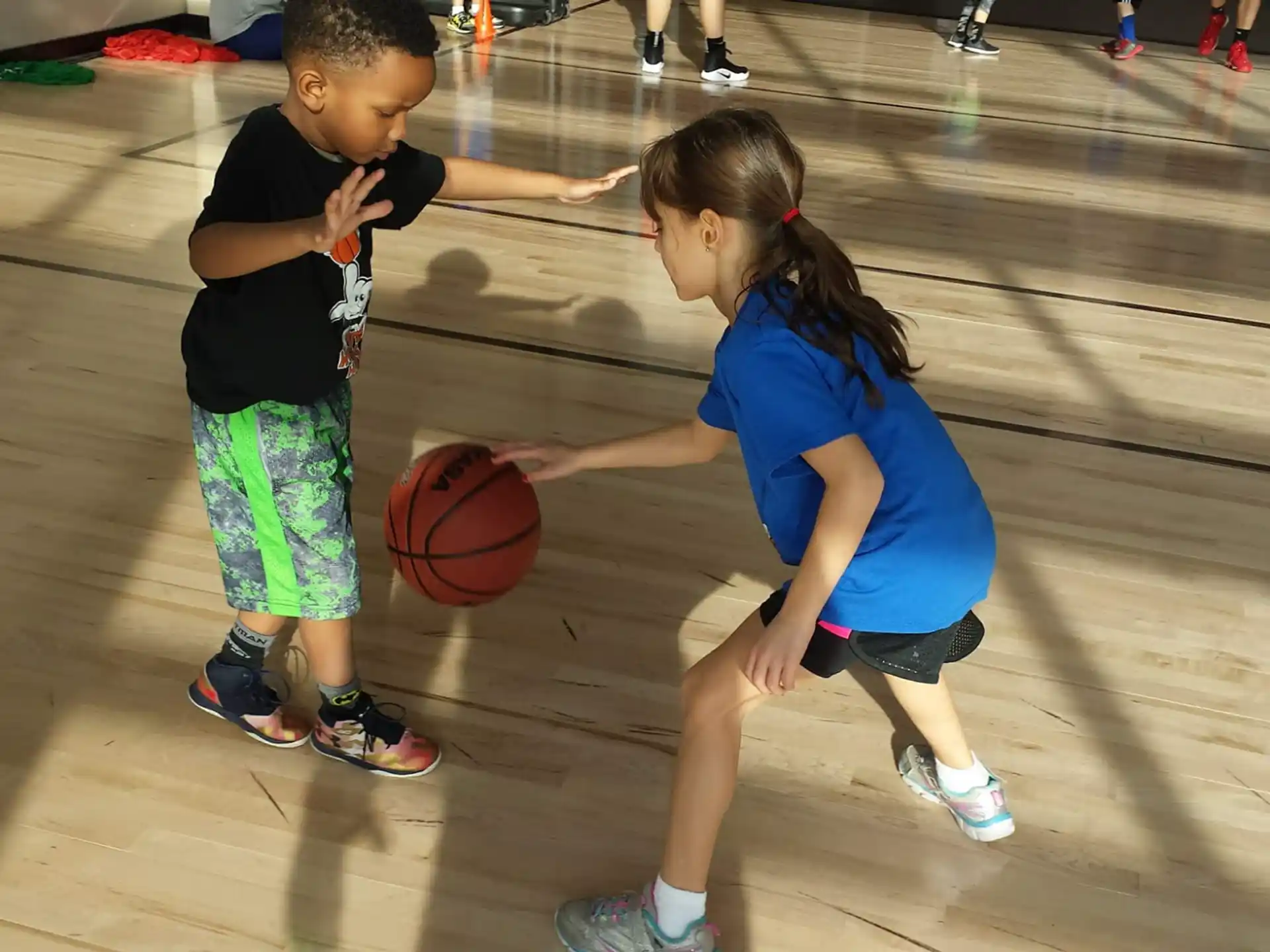 a couple of children playing basketball