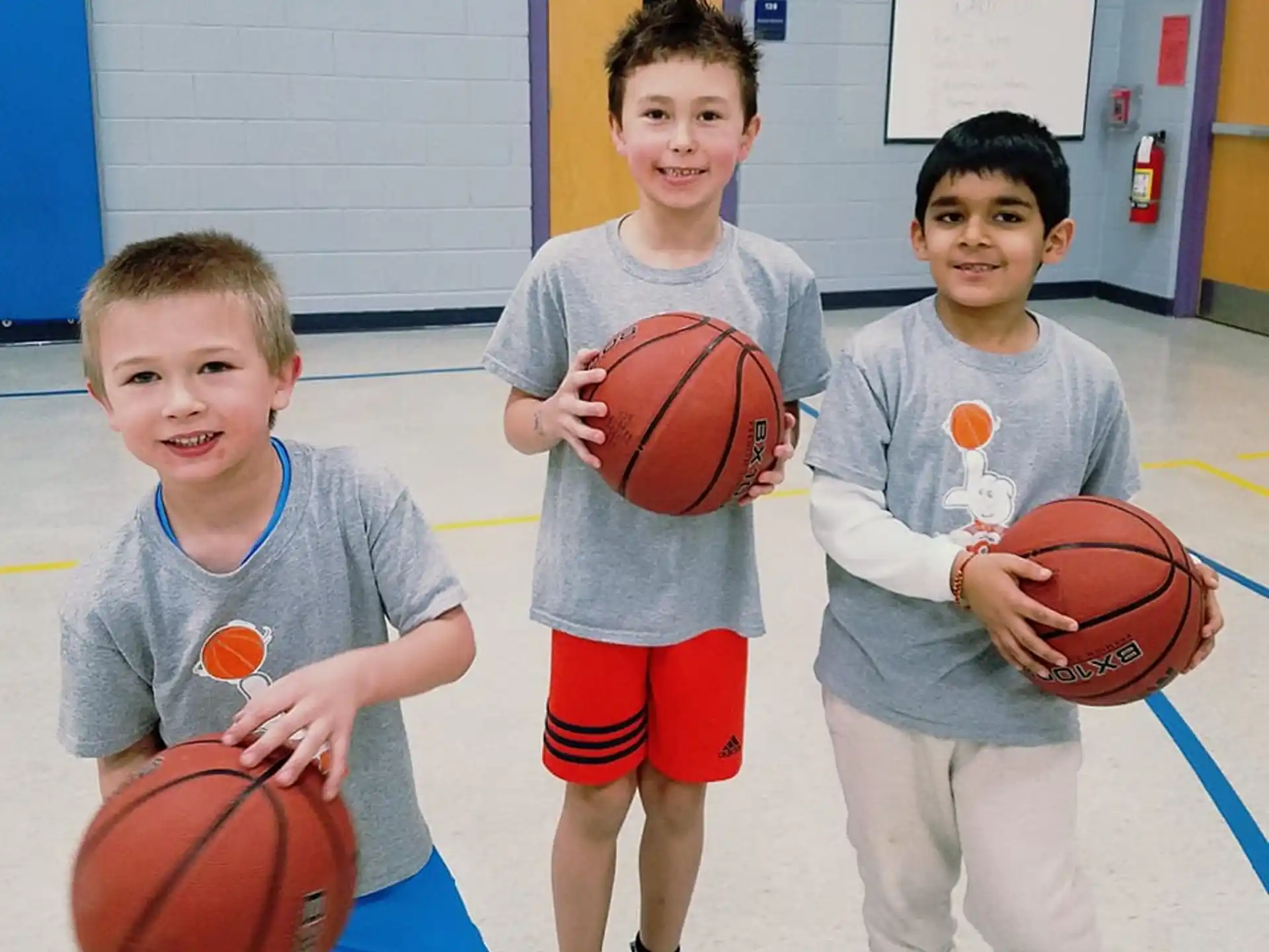 a group of boys holding basketballs