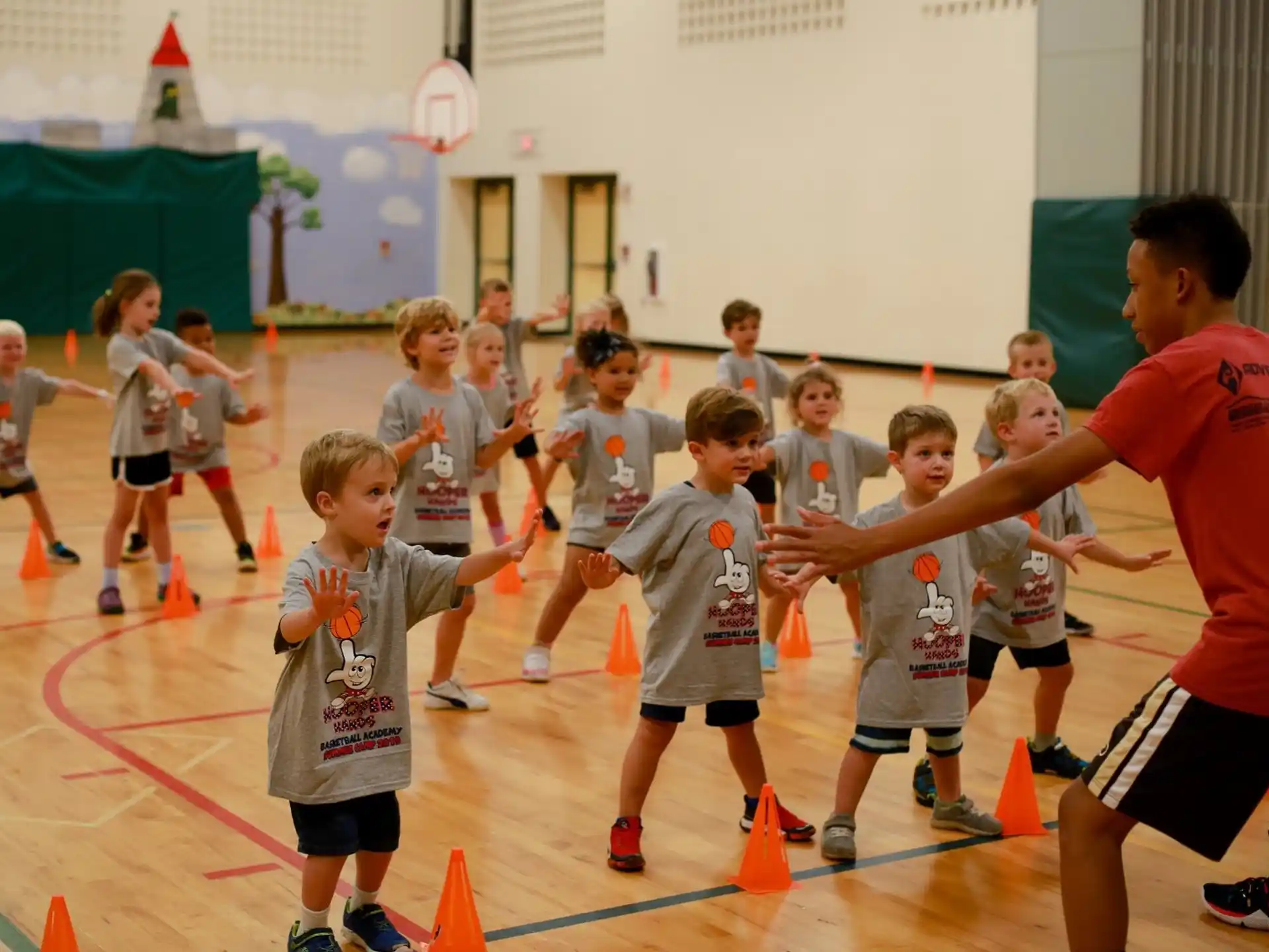 a group of kids playing basketball