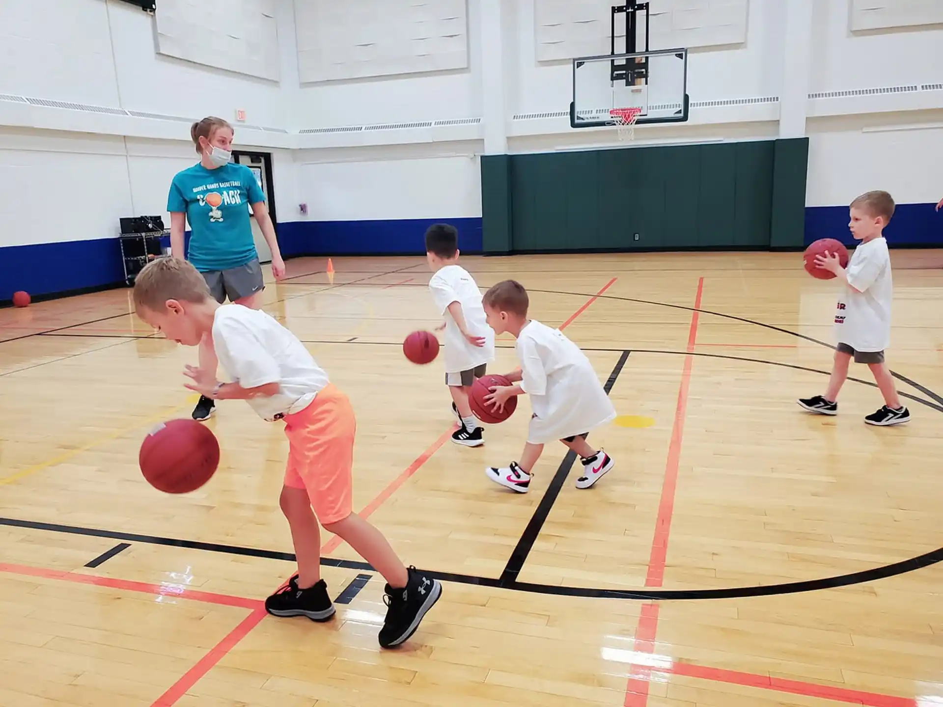 a group of kids playing basketball