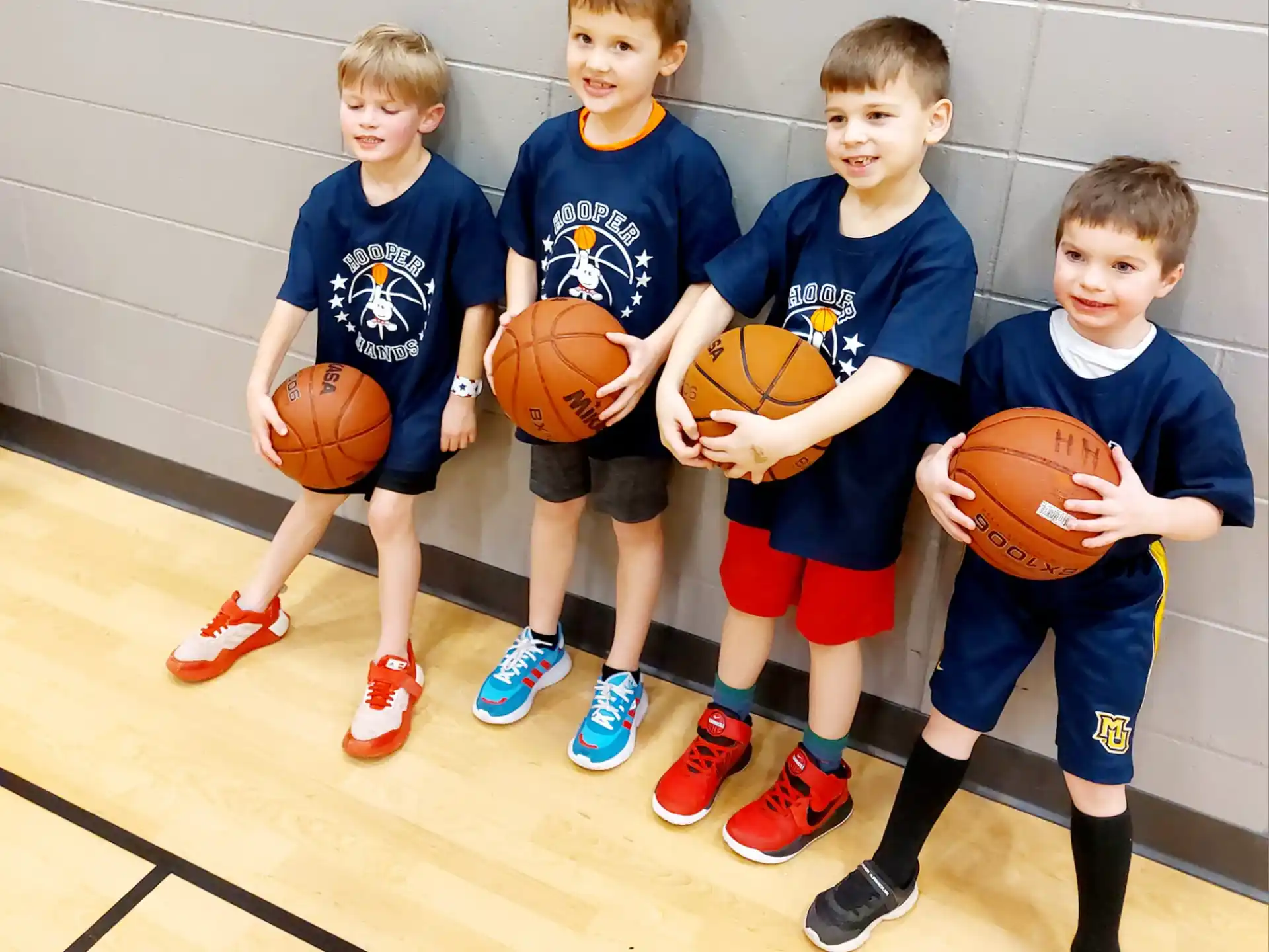 a group of boys holding basketballs