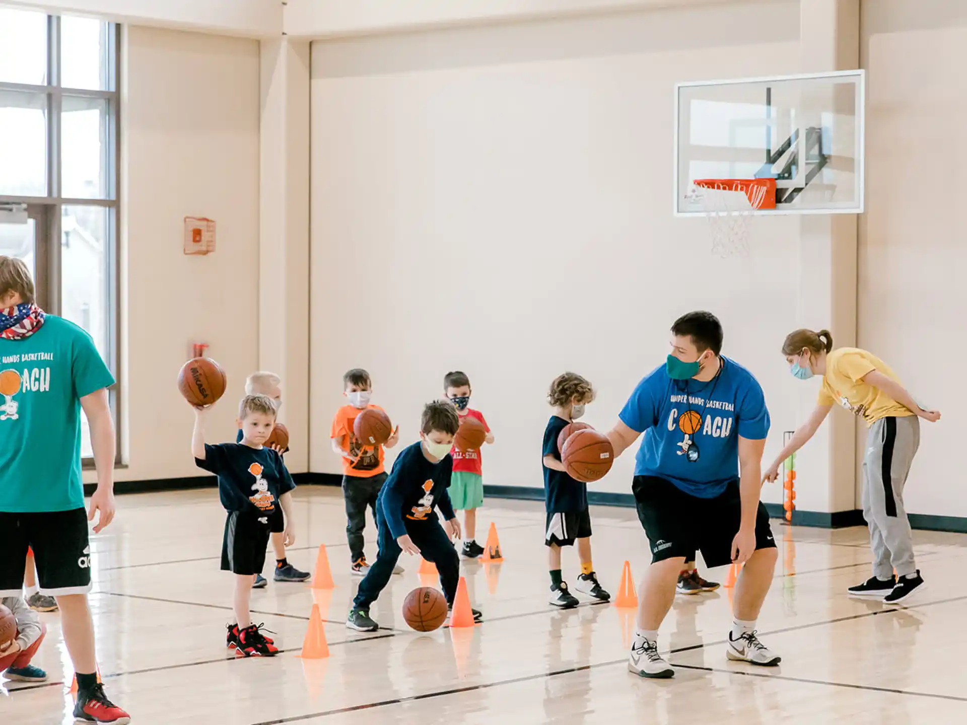 a group of kids playing basketball