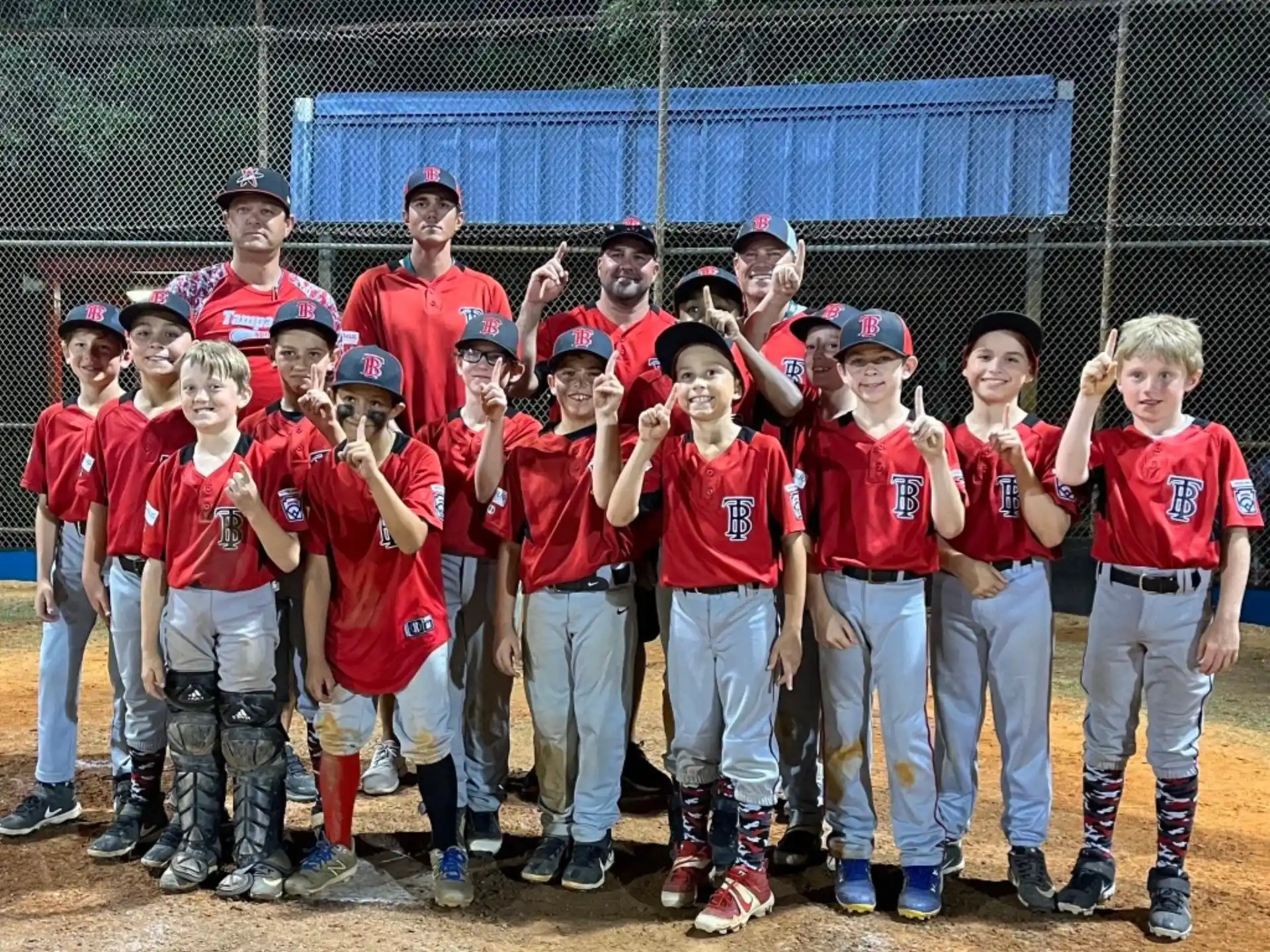 a group of kids in red shirts
