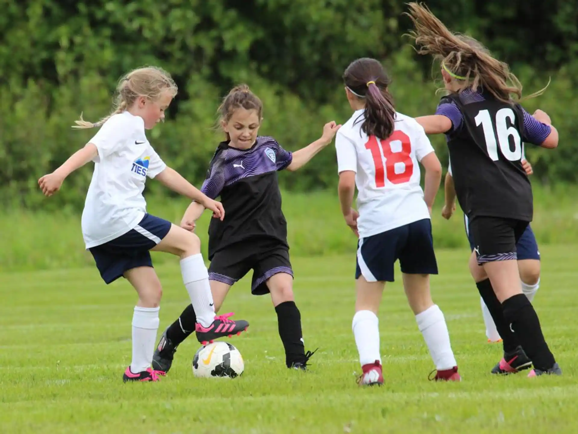 a group of girls playing football