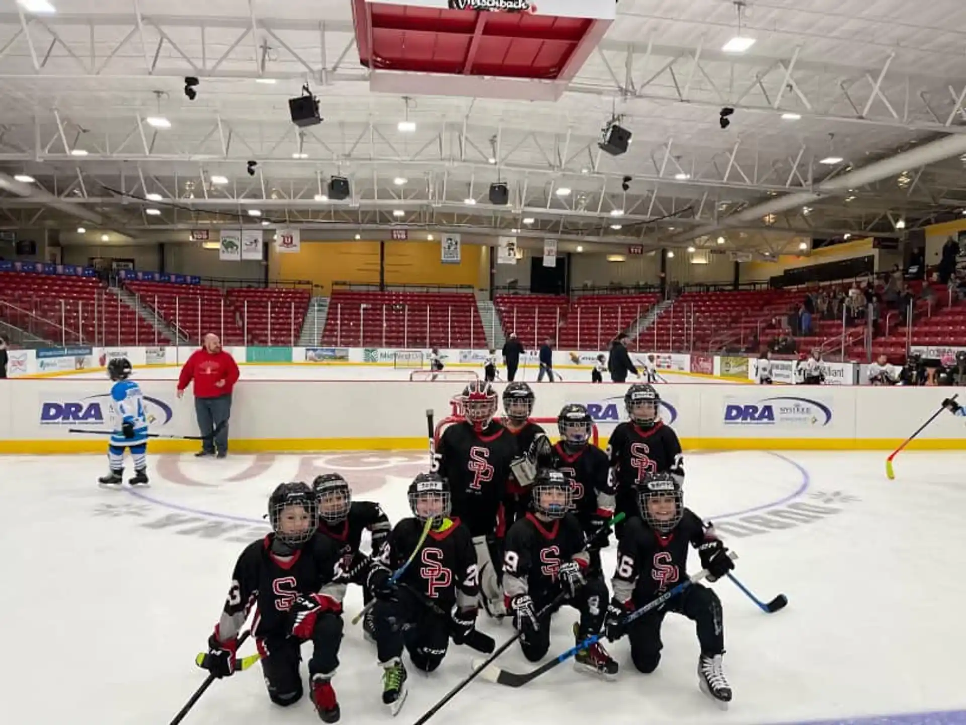 a group of people wearing hockey uniforms and holding sticks in their hands