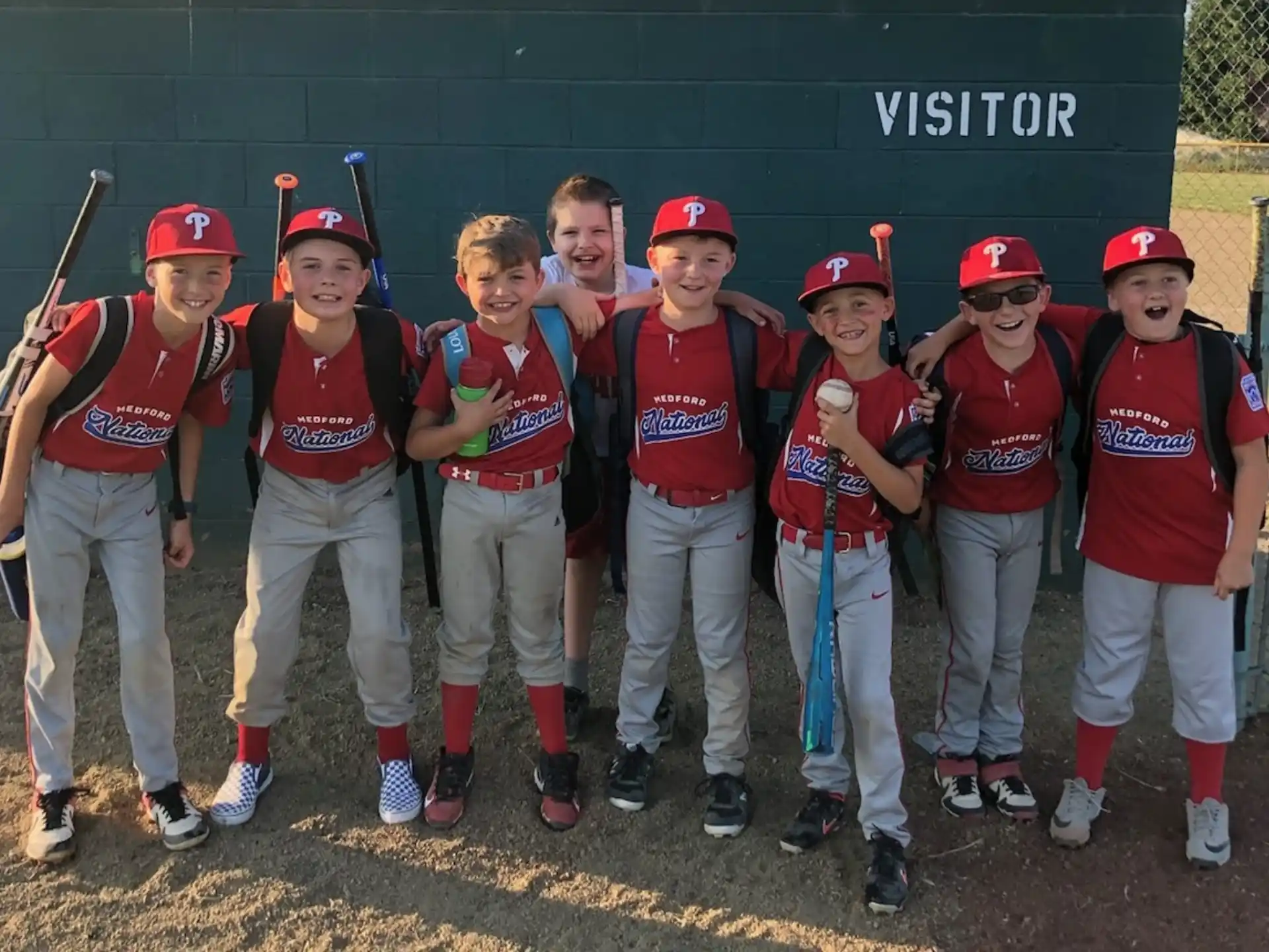 a group of kids in baseball uniforms