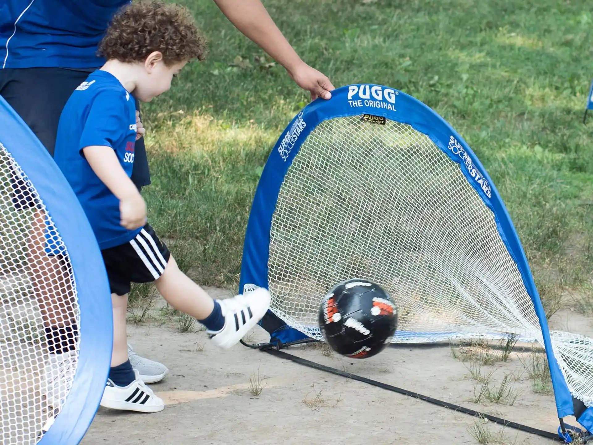 a boy playing with a ball