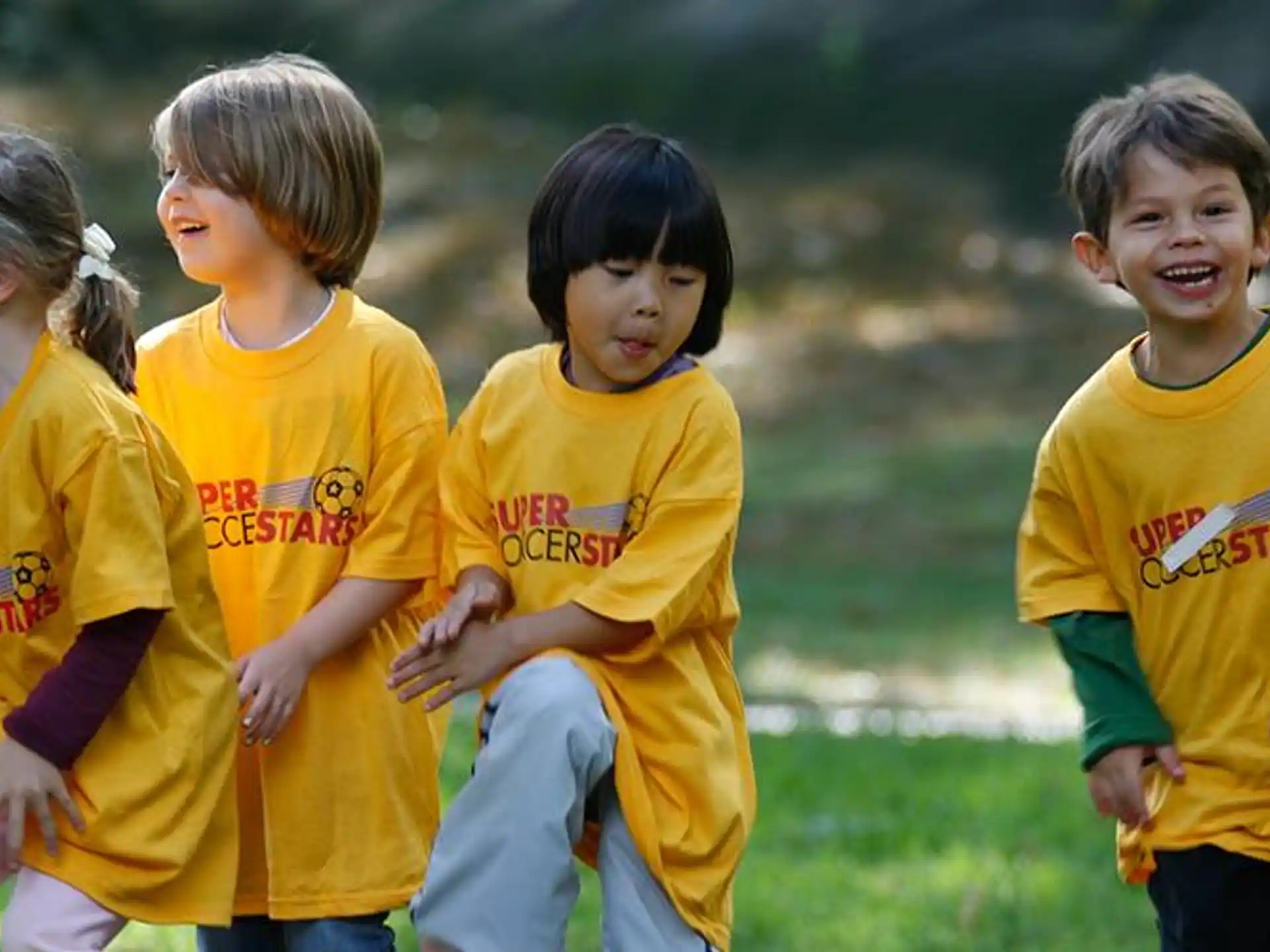 a group of children in yellow shirts