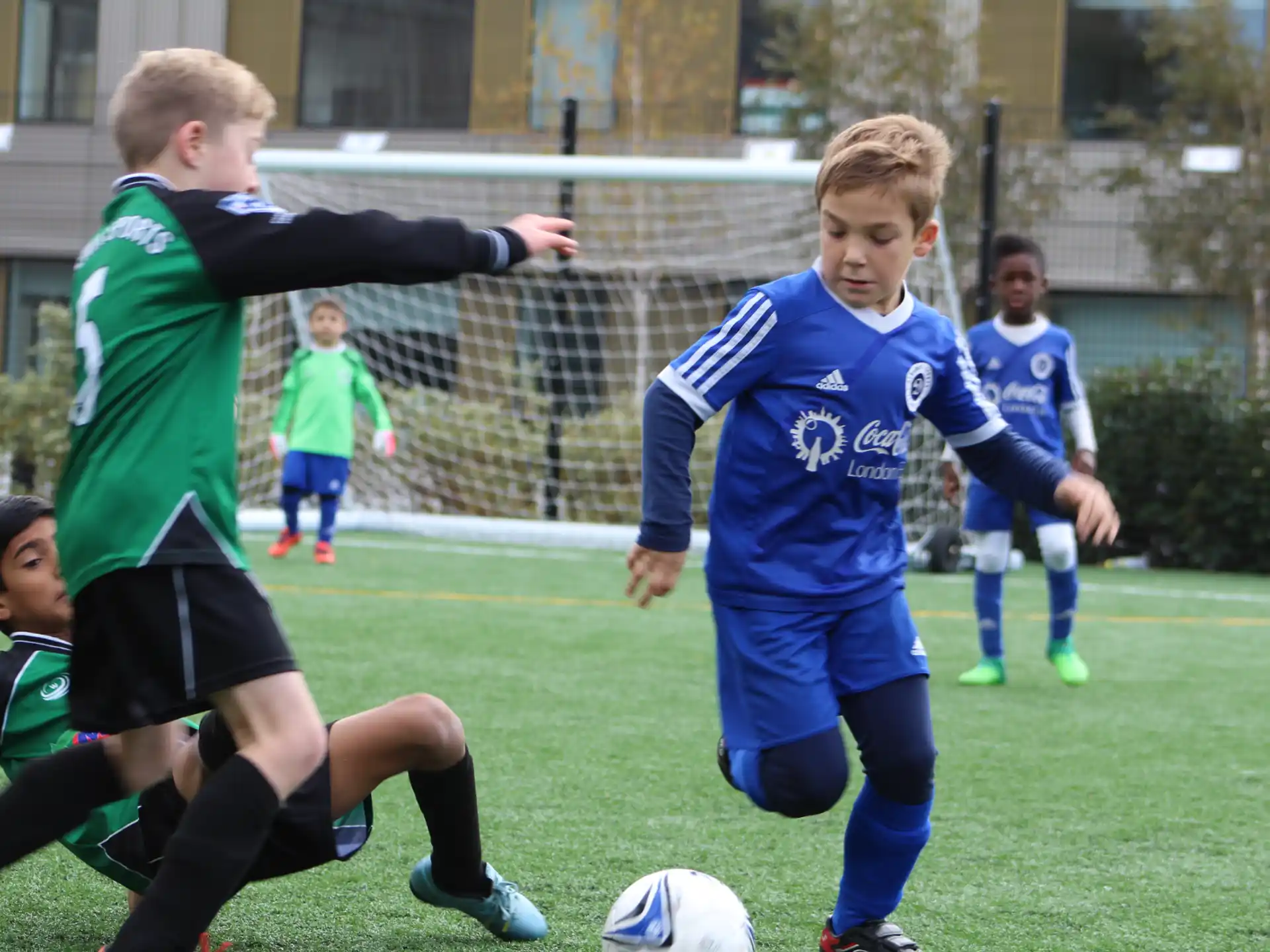 a group of kids playing football