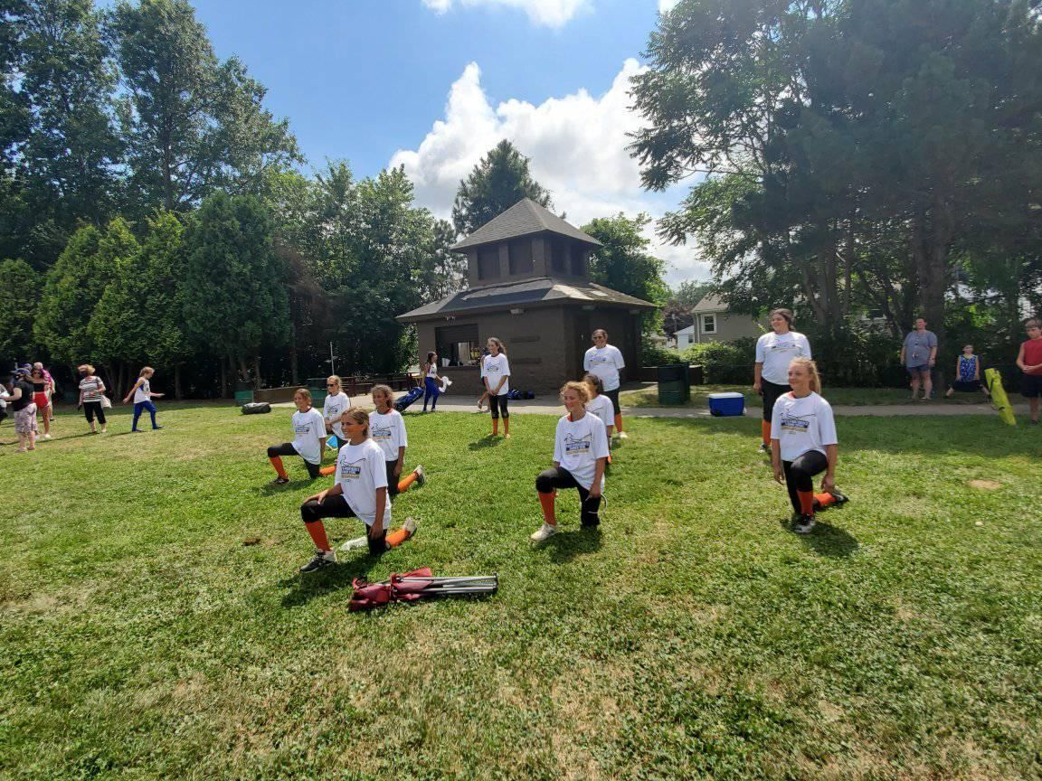 a group of people playing baseball