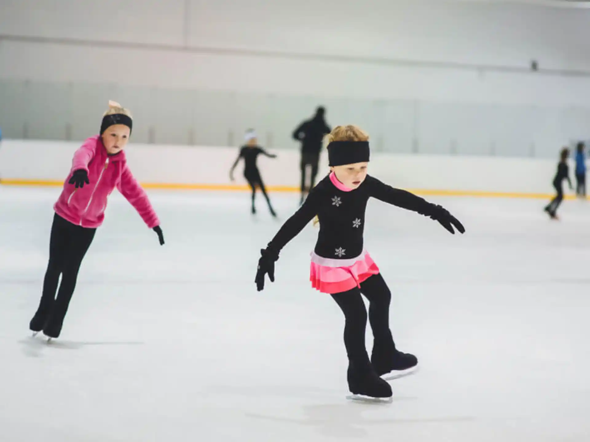 a couple of people ice skating