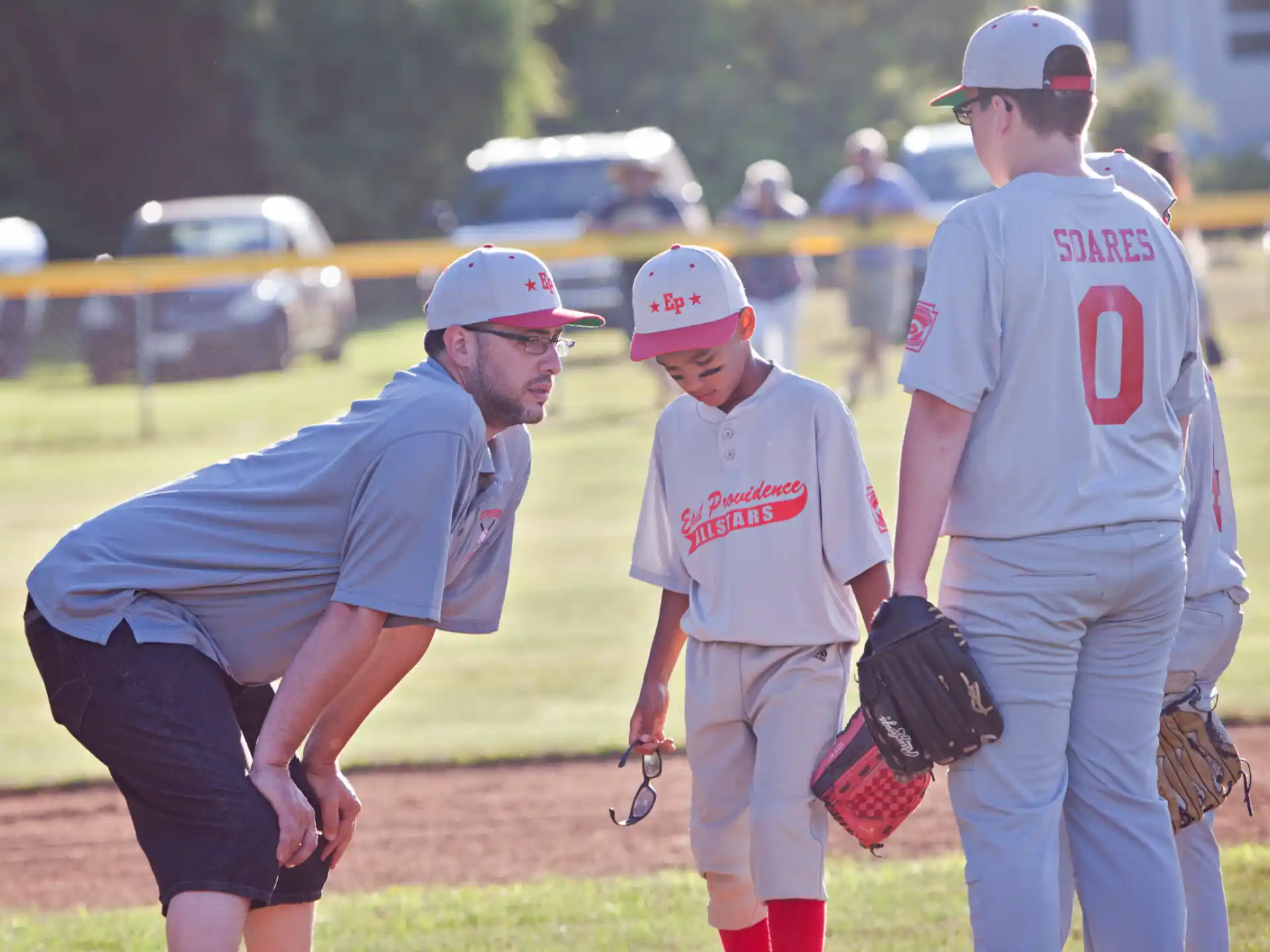 a baseball player is talking to his kids