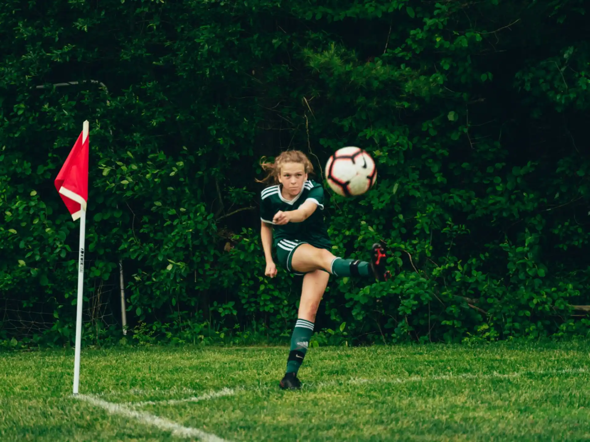 a girl kicking a football ball