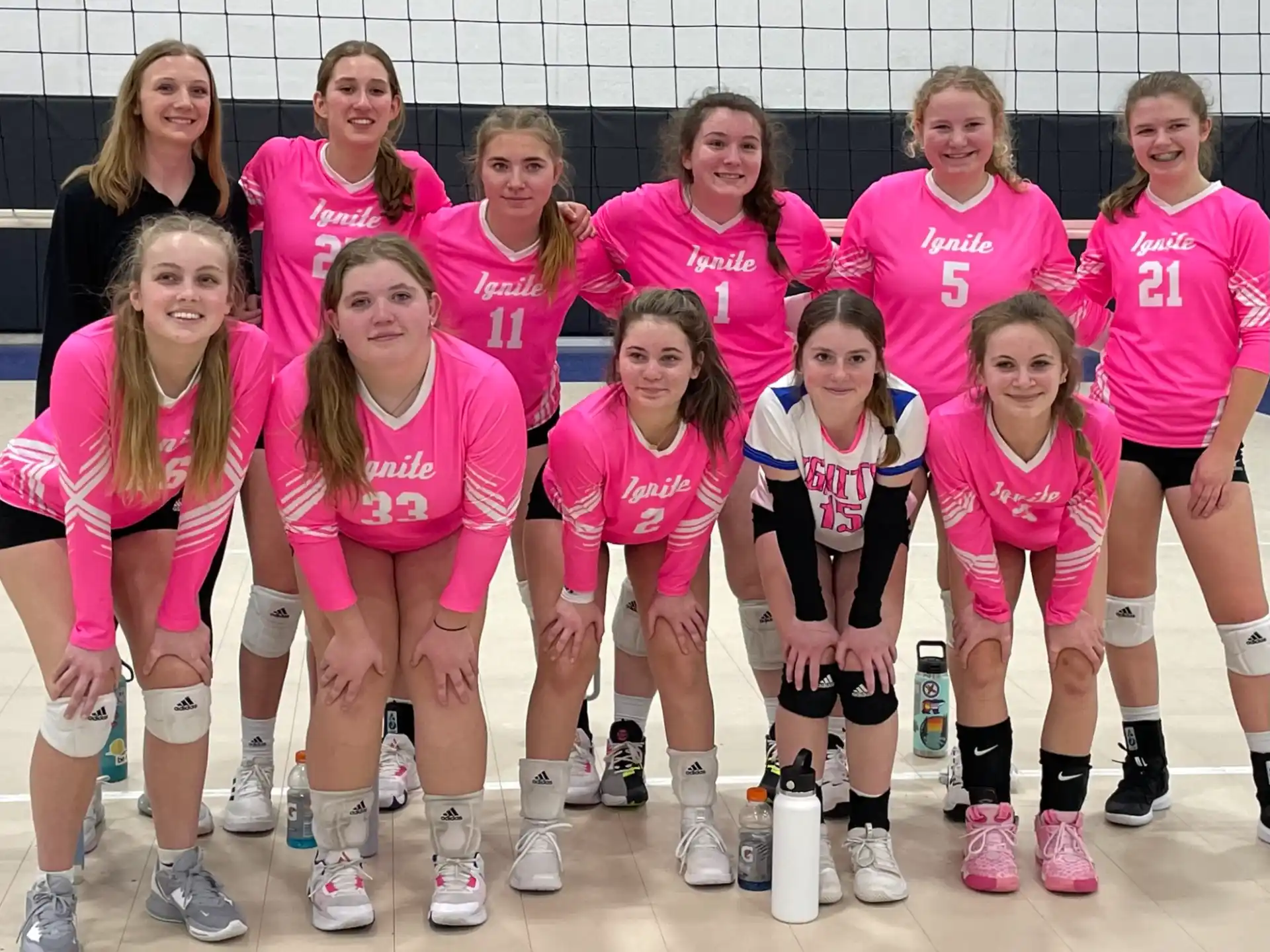 a group of women in pink shirts