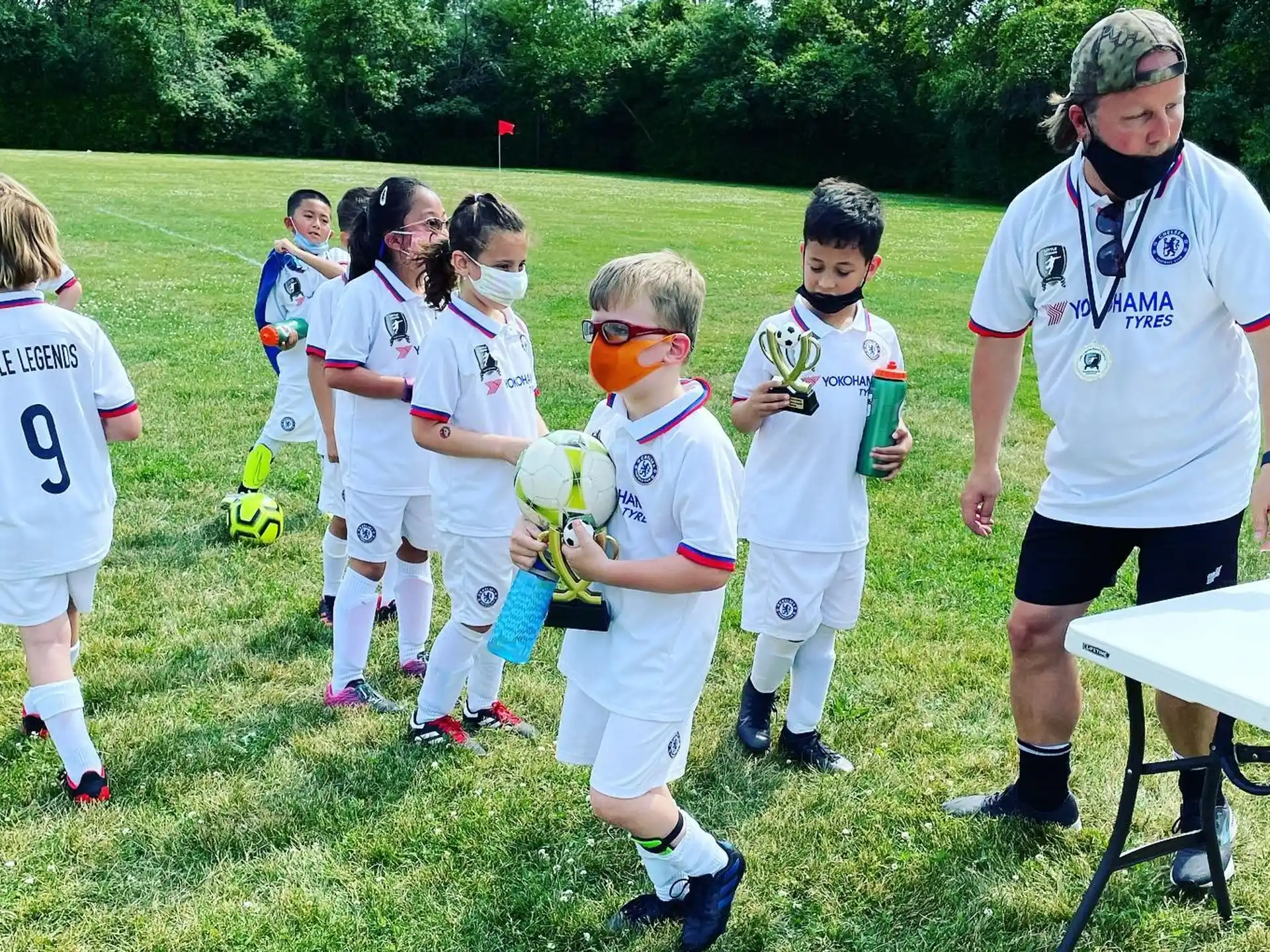 a group of kids in football uniforms