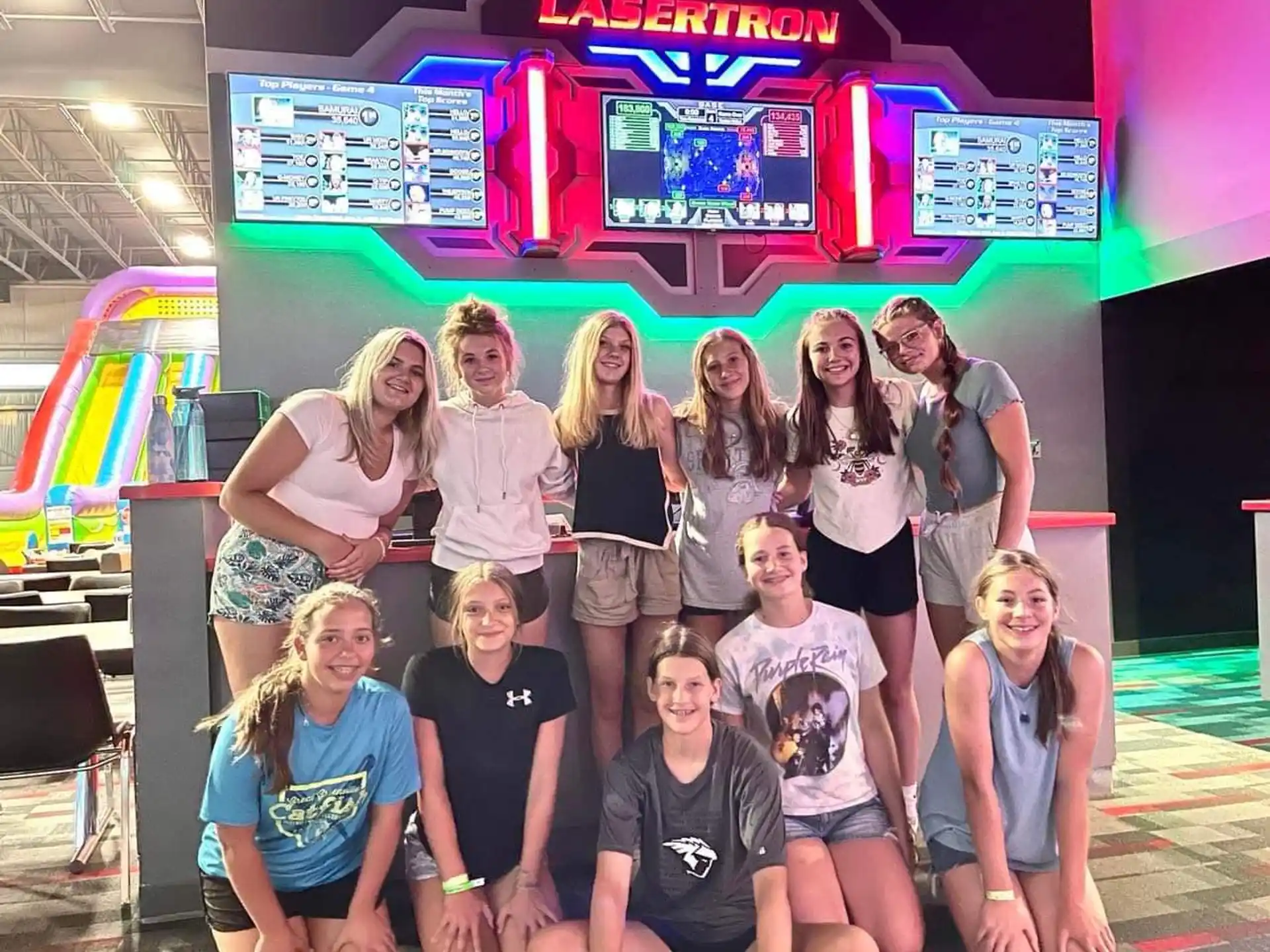 a group of people posing for a photo in front of a sign