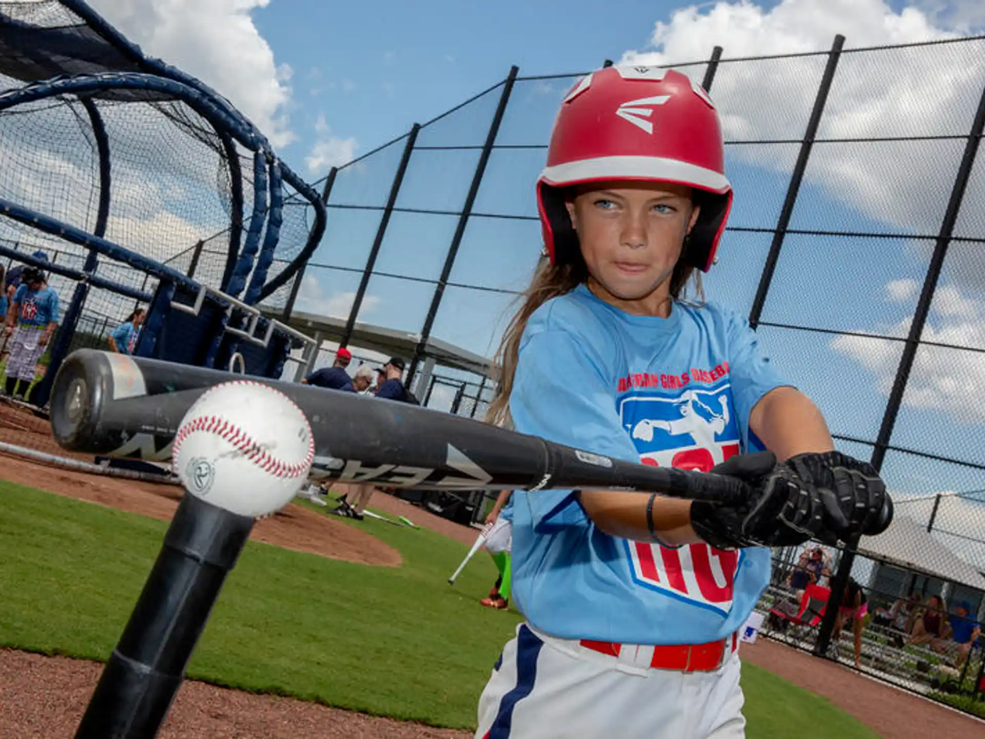 a young girl playing baseball
