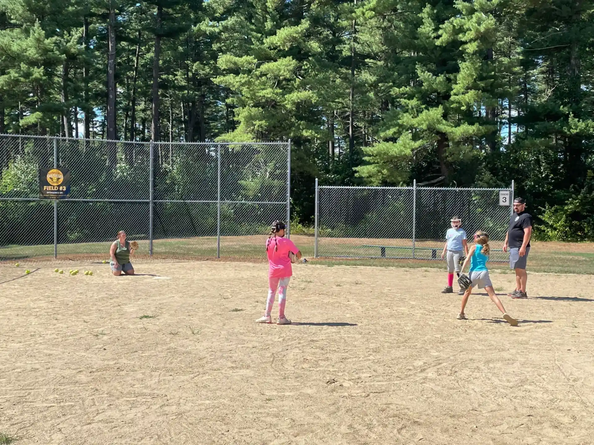a group of people playing baseball