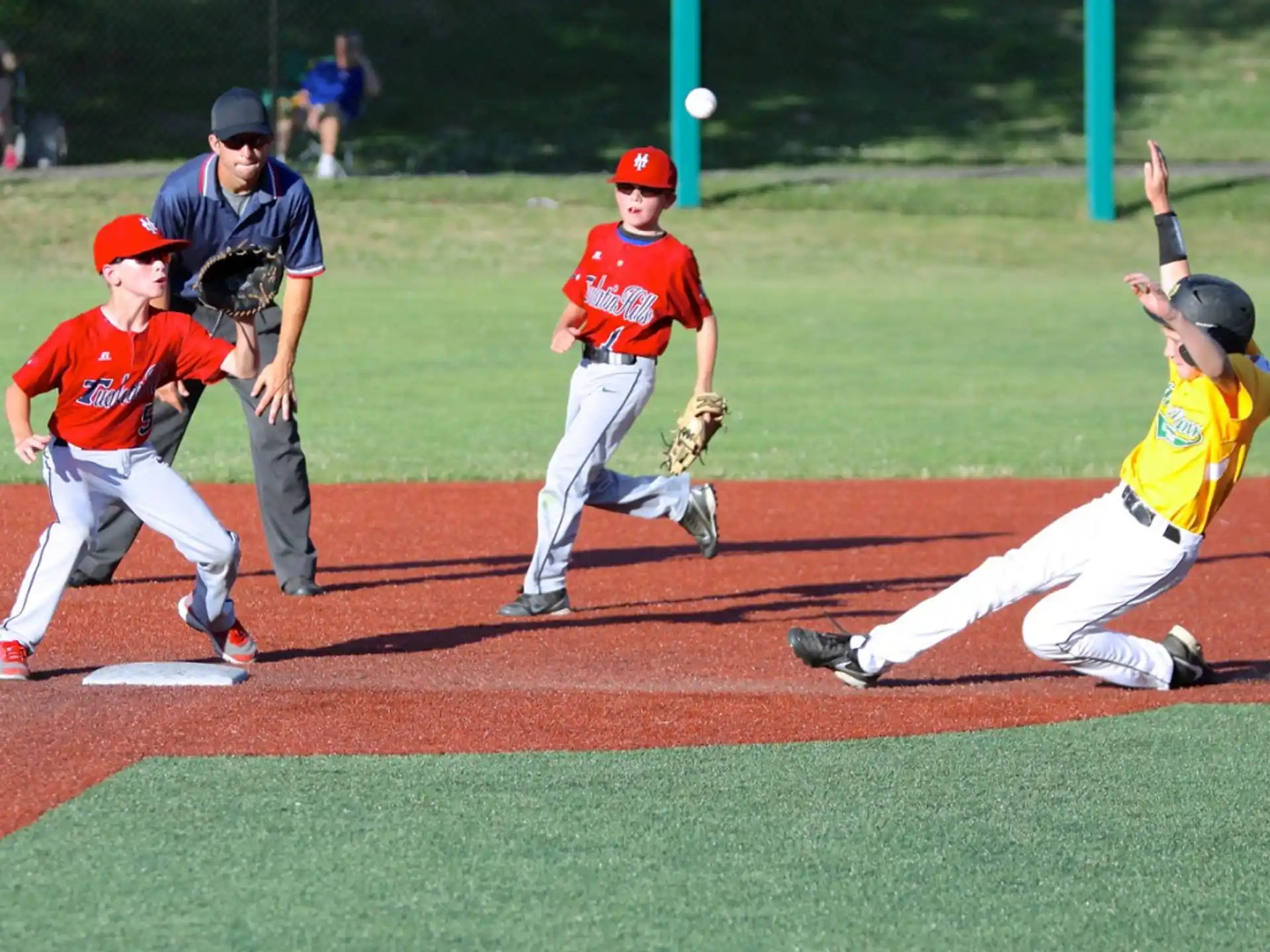 a group of kids playing baseball