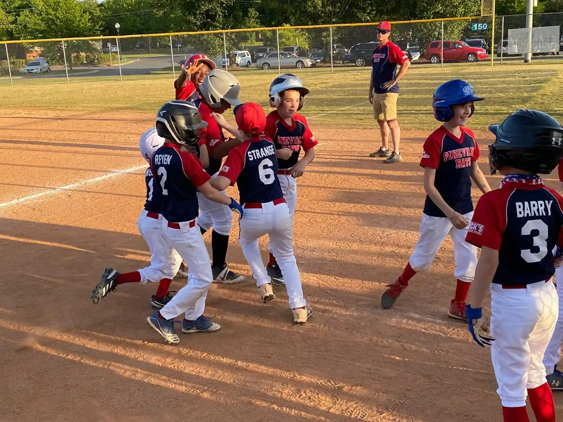 a group of kids playing baseball