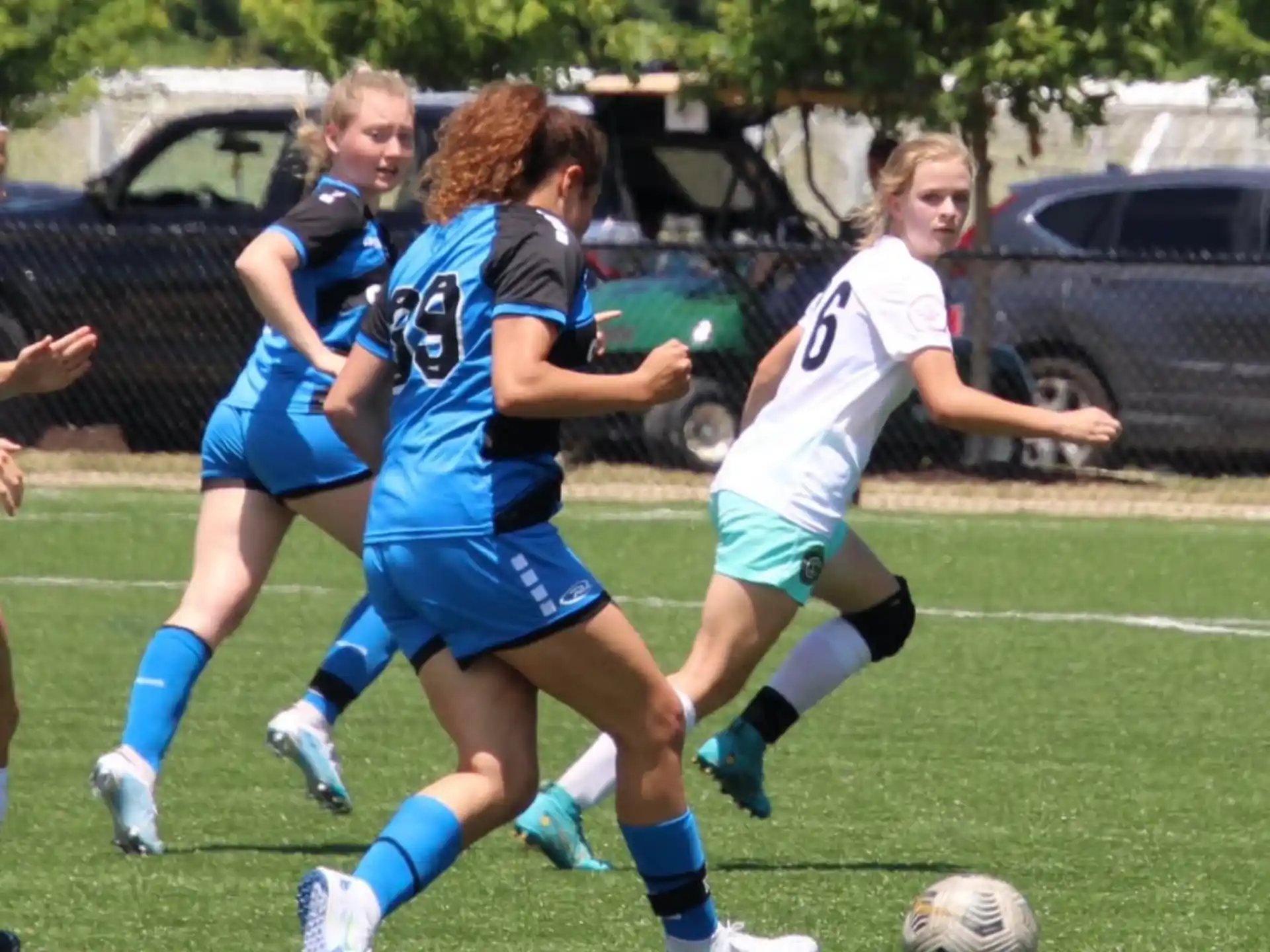 girls playing football on a field
