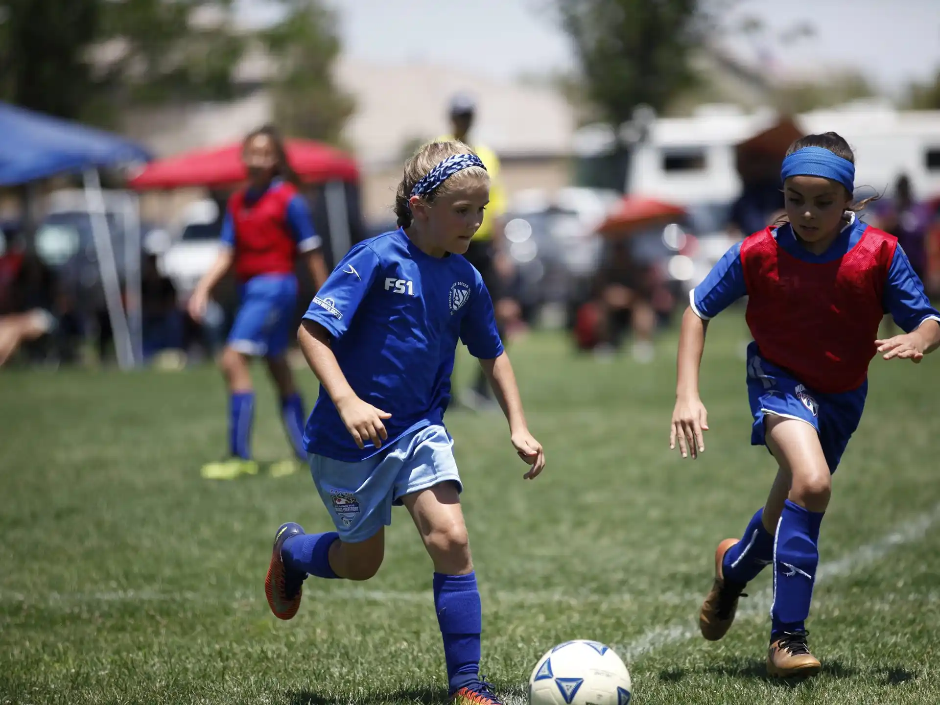girls playing football on a field