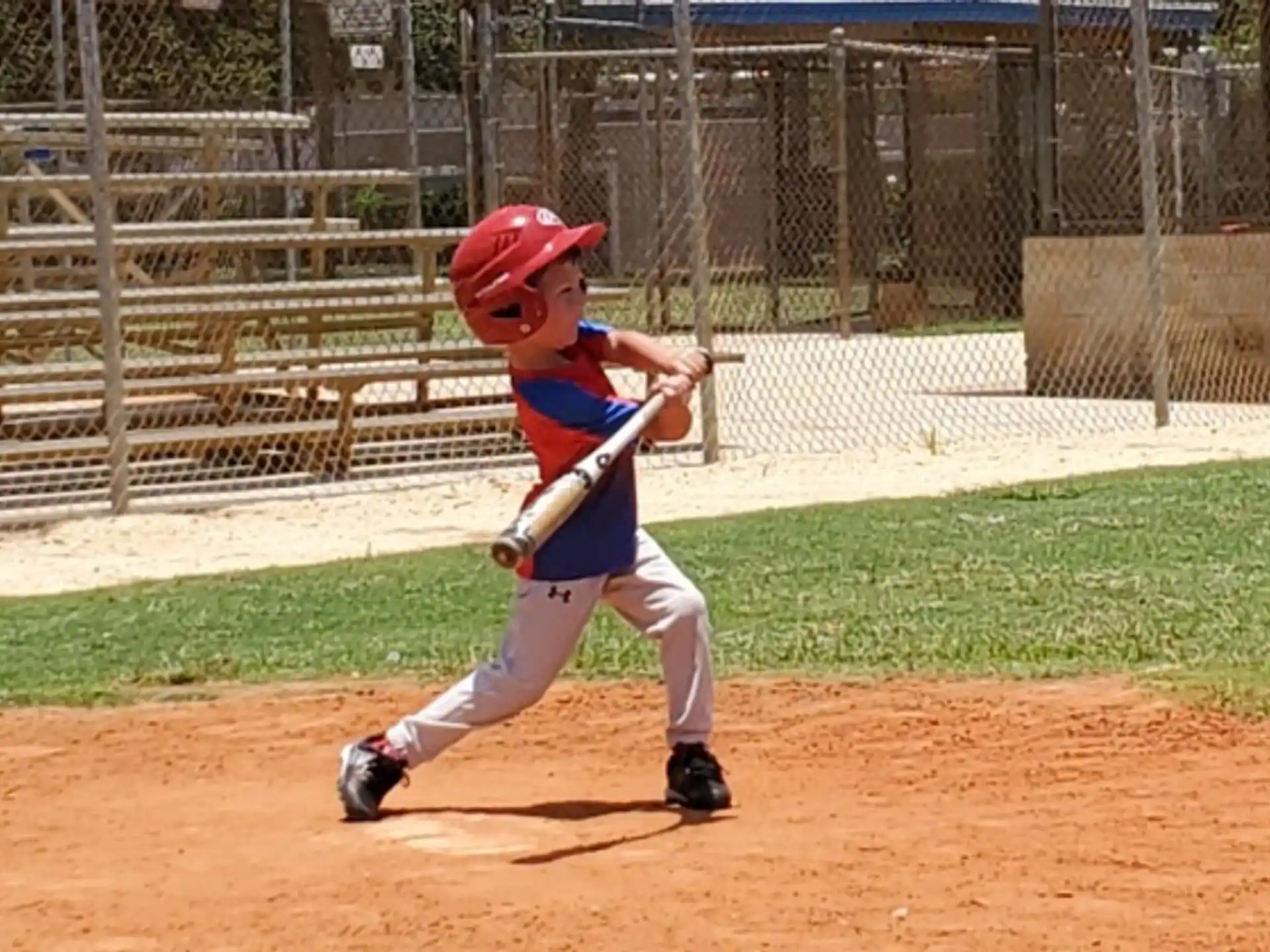 a kid swinging a baseball bat