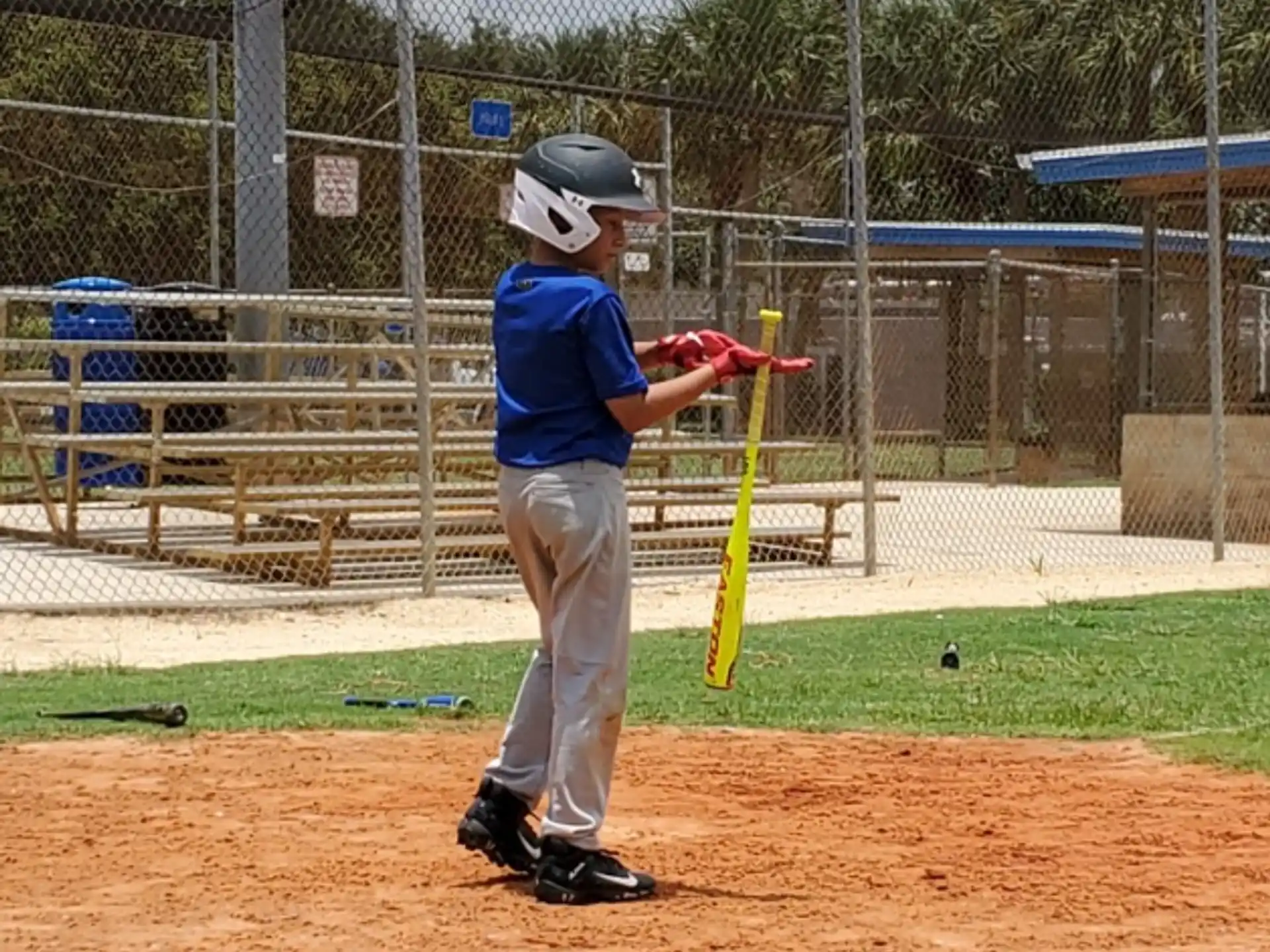 a kid swinging a baseball bat