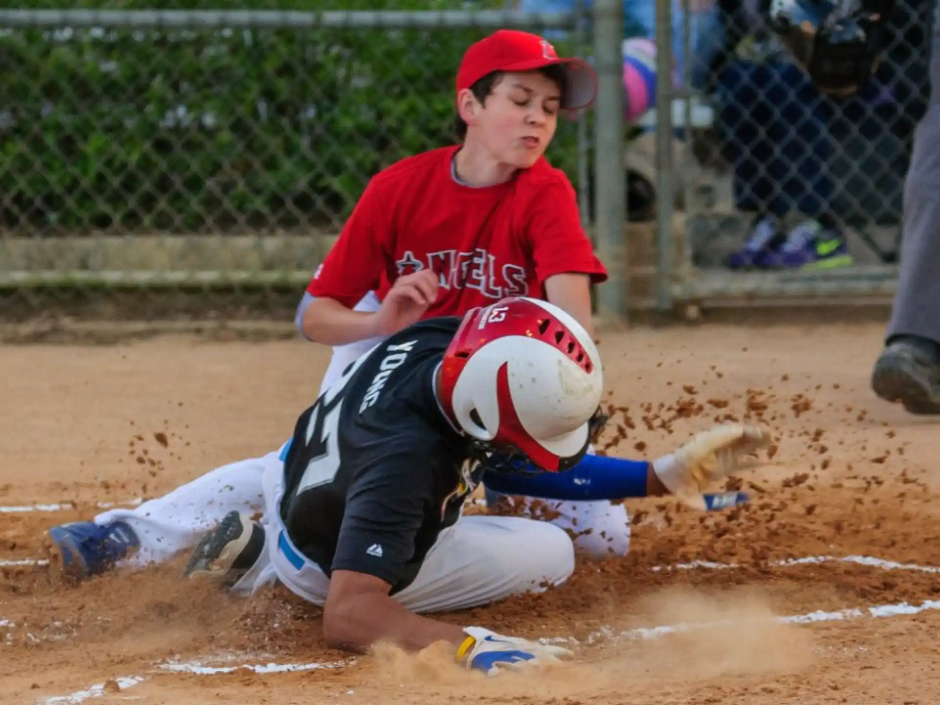 a boy sliding into a base