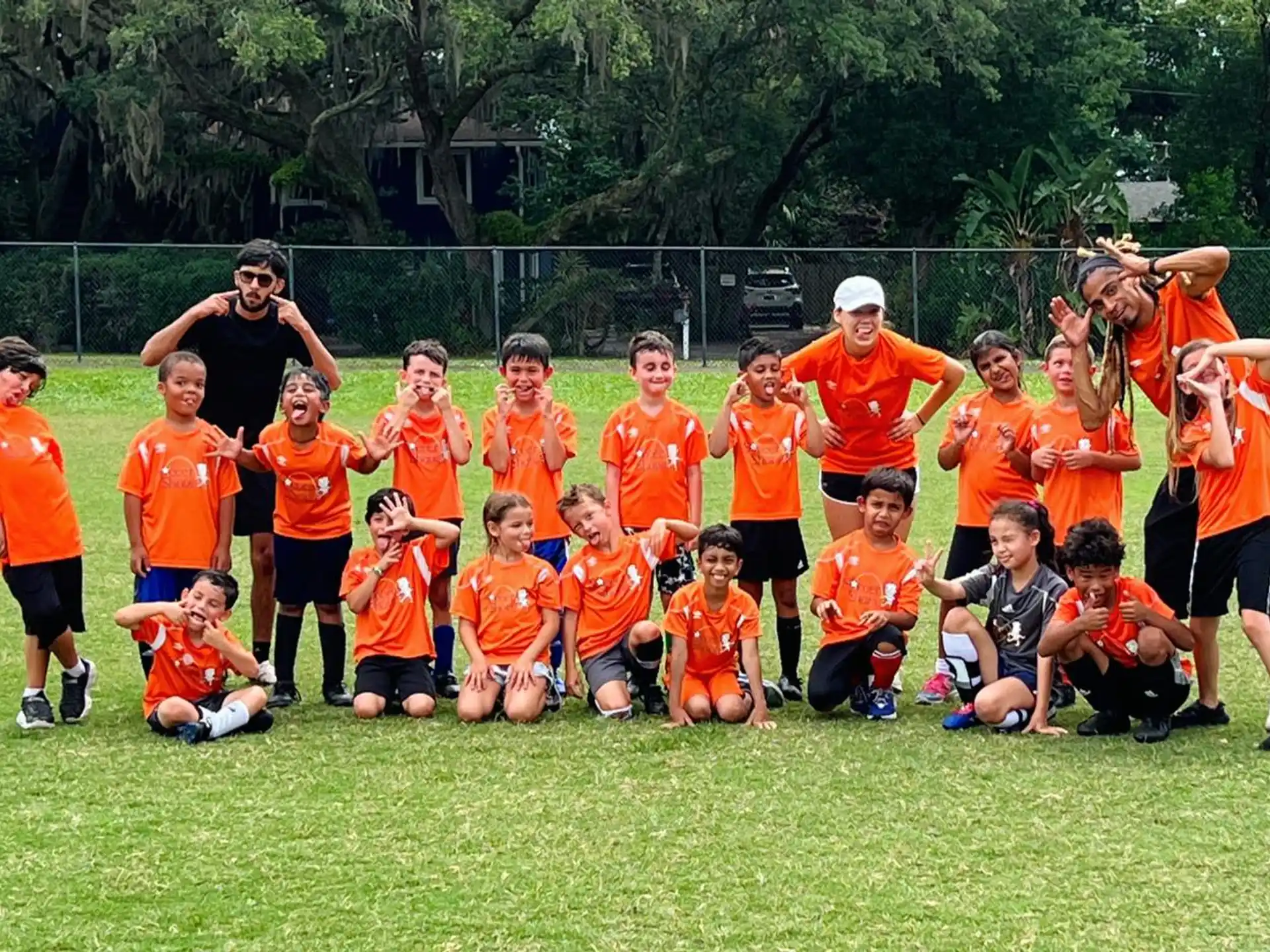 a group of people in orange shirts