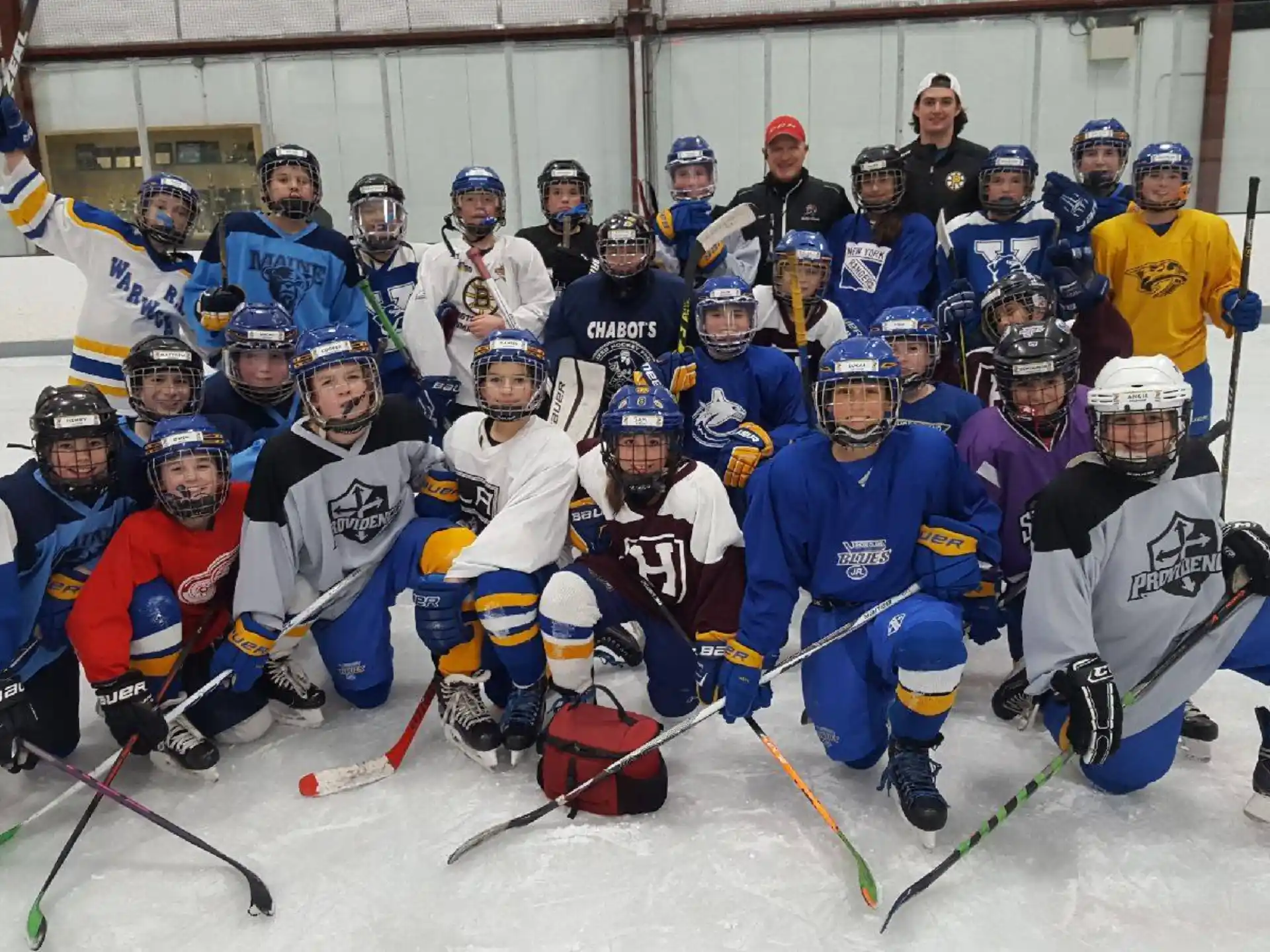 a group of hockey players posing for a photo