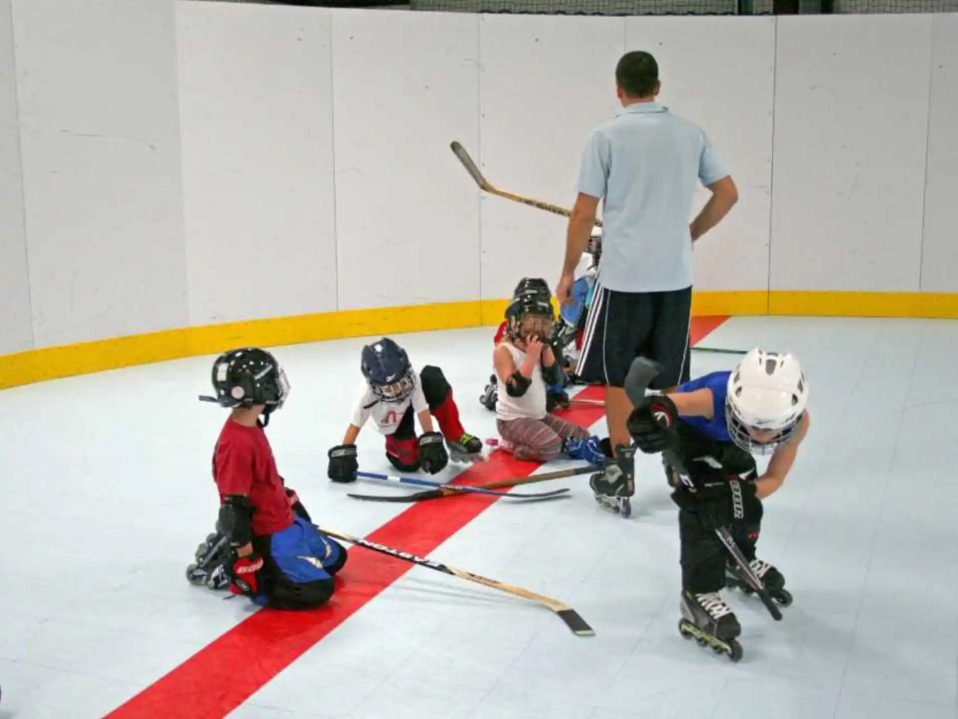 a group of kids playing hockey