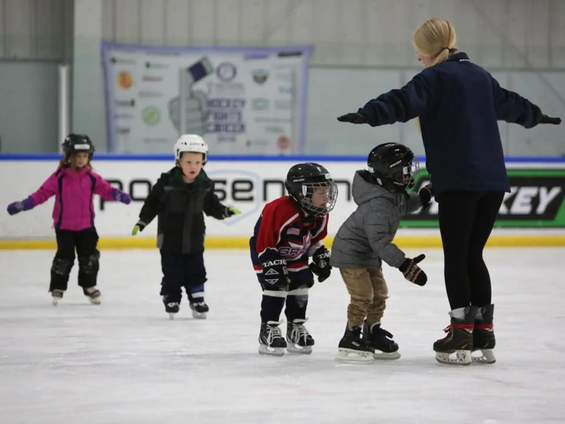 a person and kids on ice skates