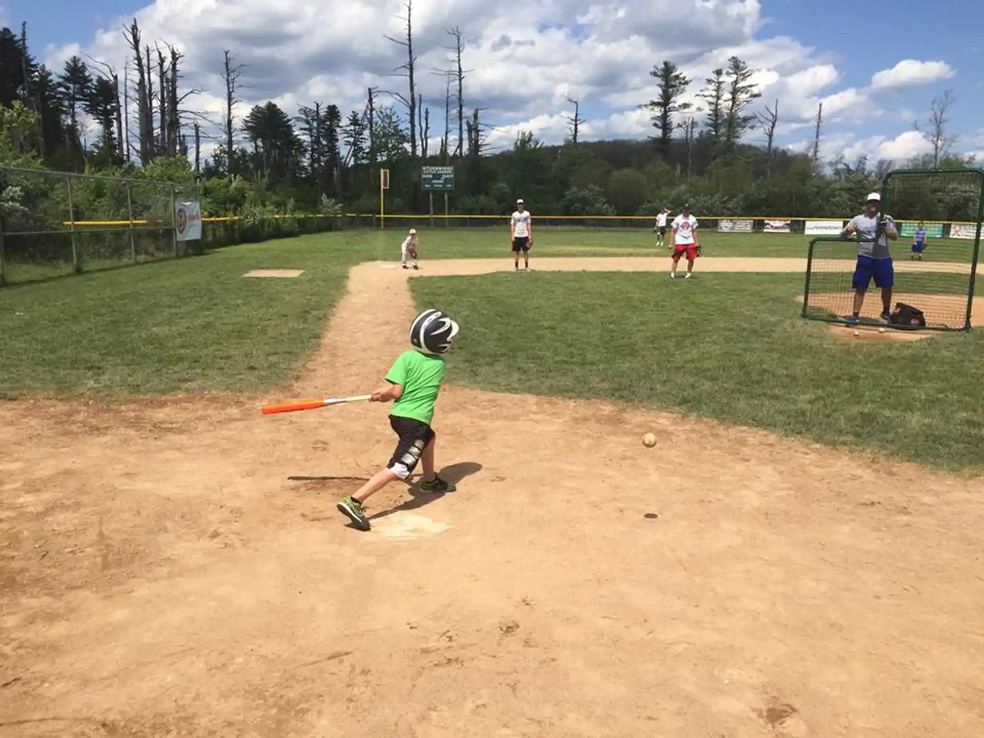 a kid swinging a baseball bat