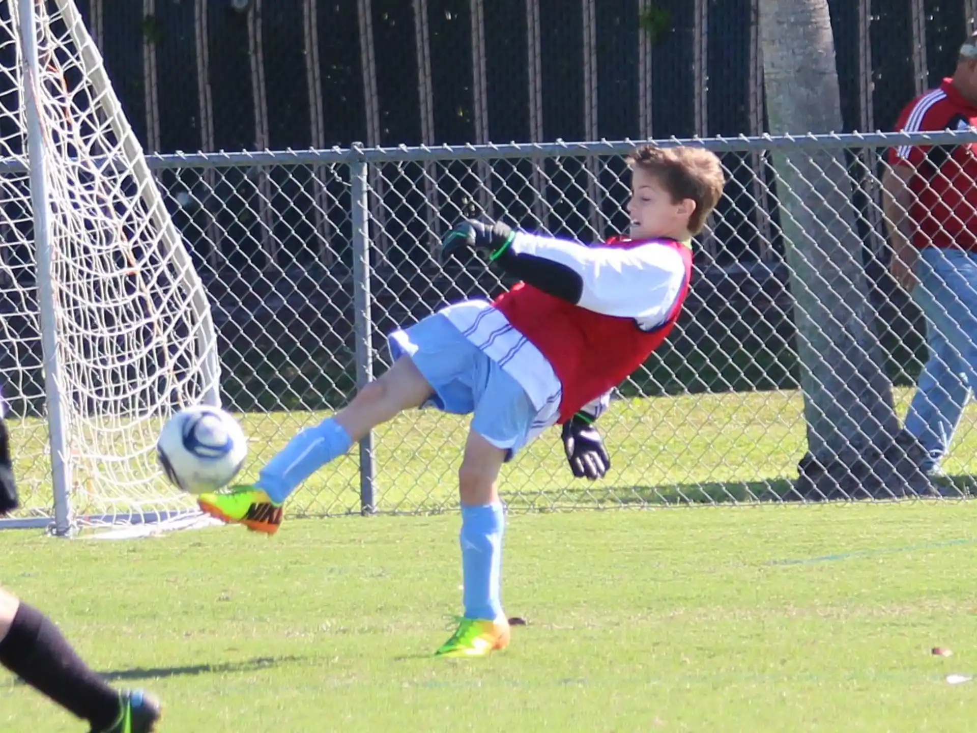 a boy kicking a football ball