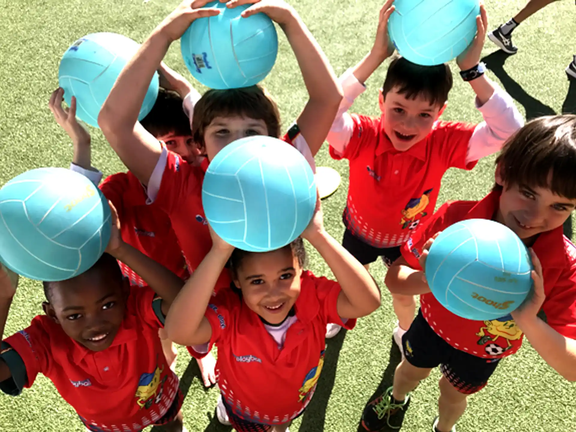 a group of kids holding blue balloons