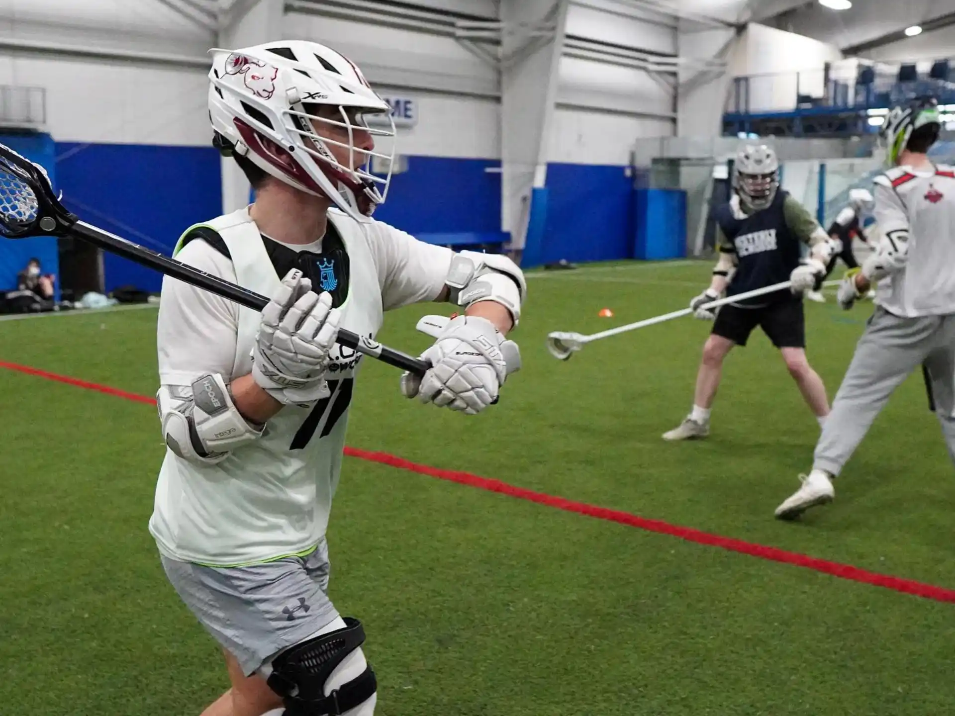a group of people playing lacrosse
