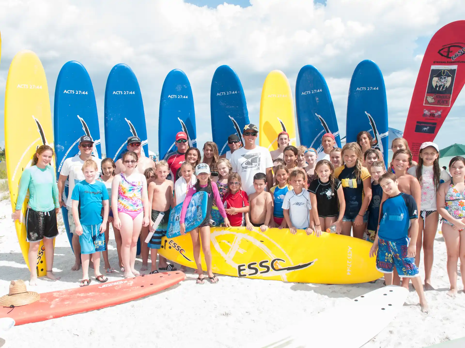 a group of people posing for a photo with surfboards