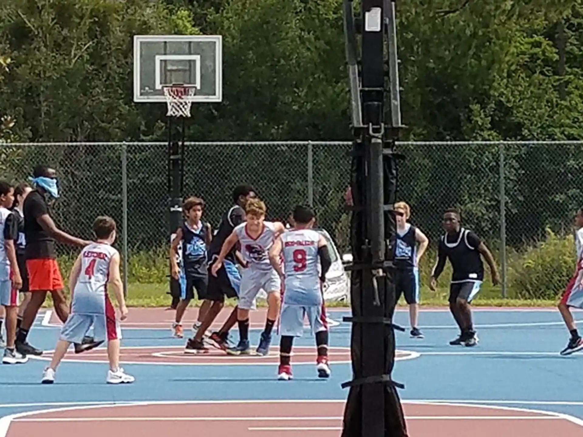 a group of kids playing basketball
