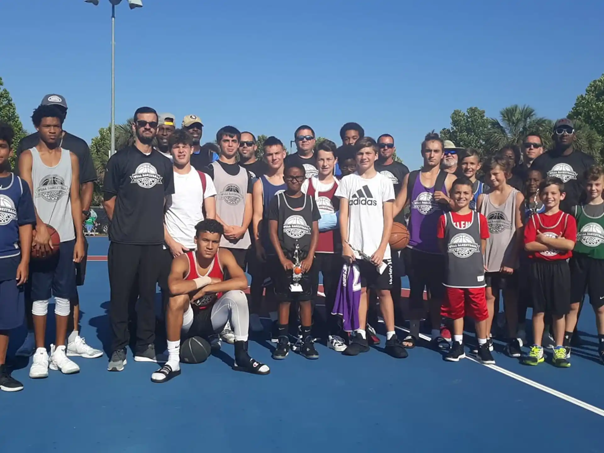 a group of people posing for a photo on a track
