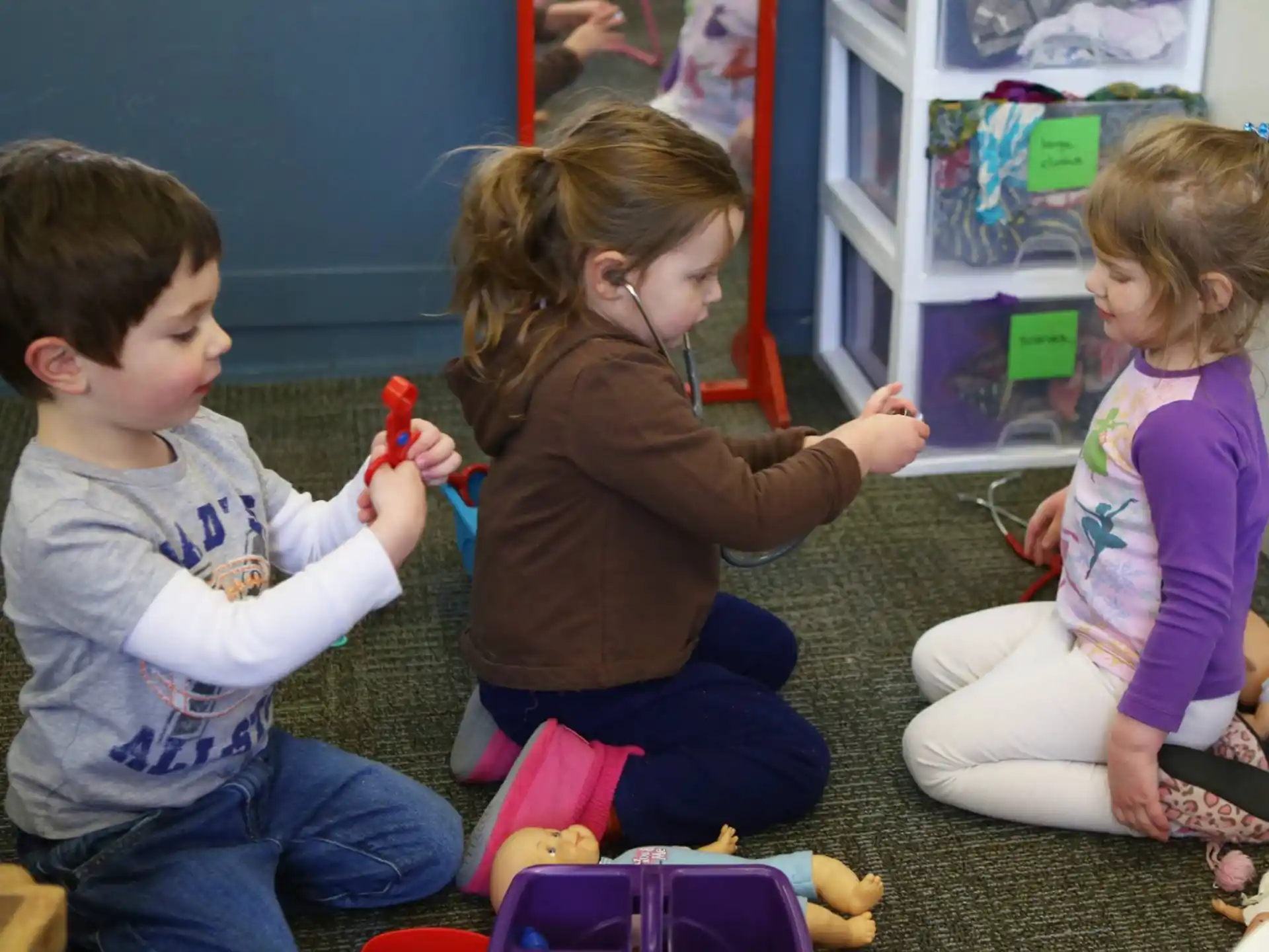 a group of children playing with toys