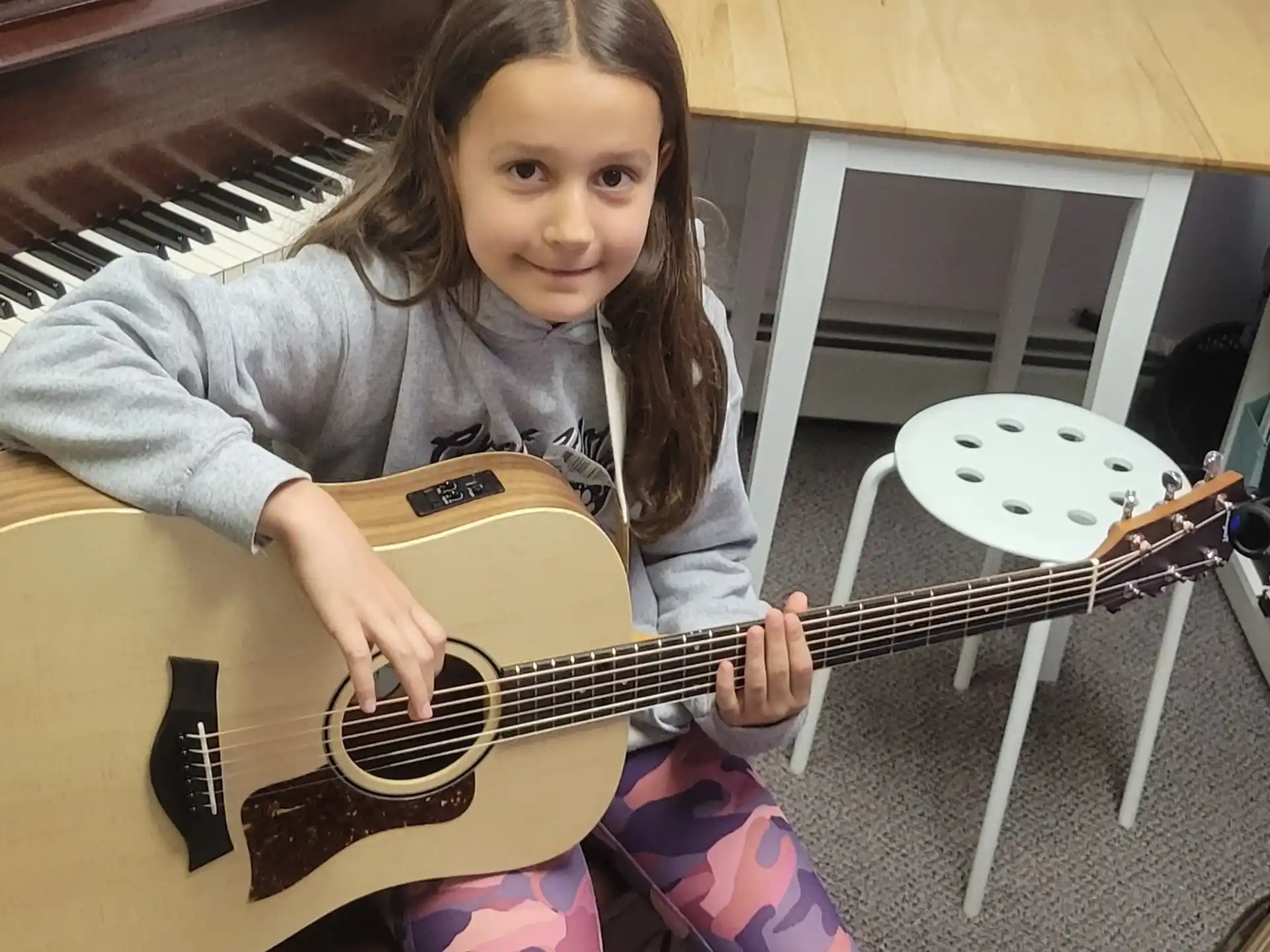 a girl holding a guitar