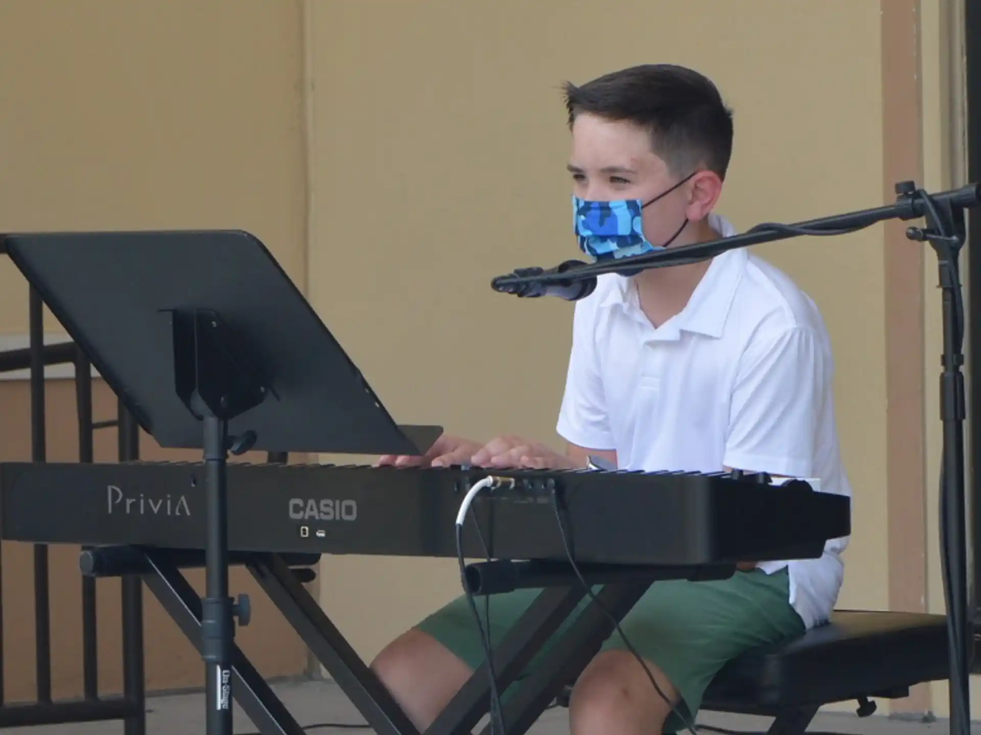 a boy playing a piano