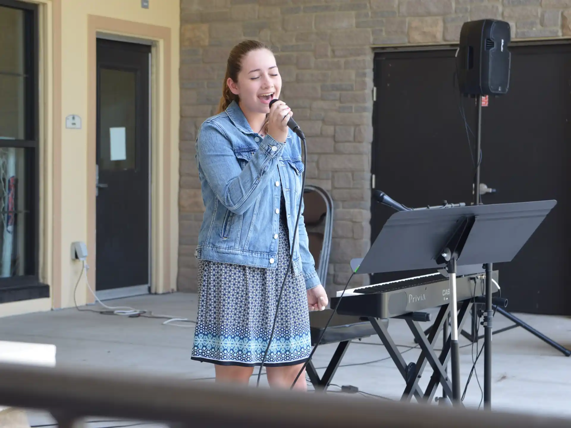 a woman singing into a microphone