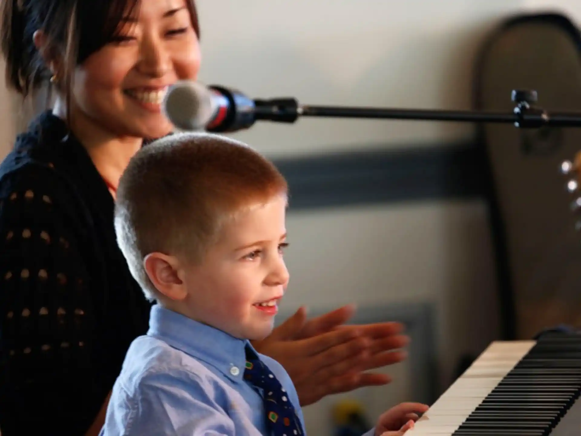 a person and a child playing piano
