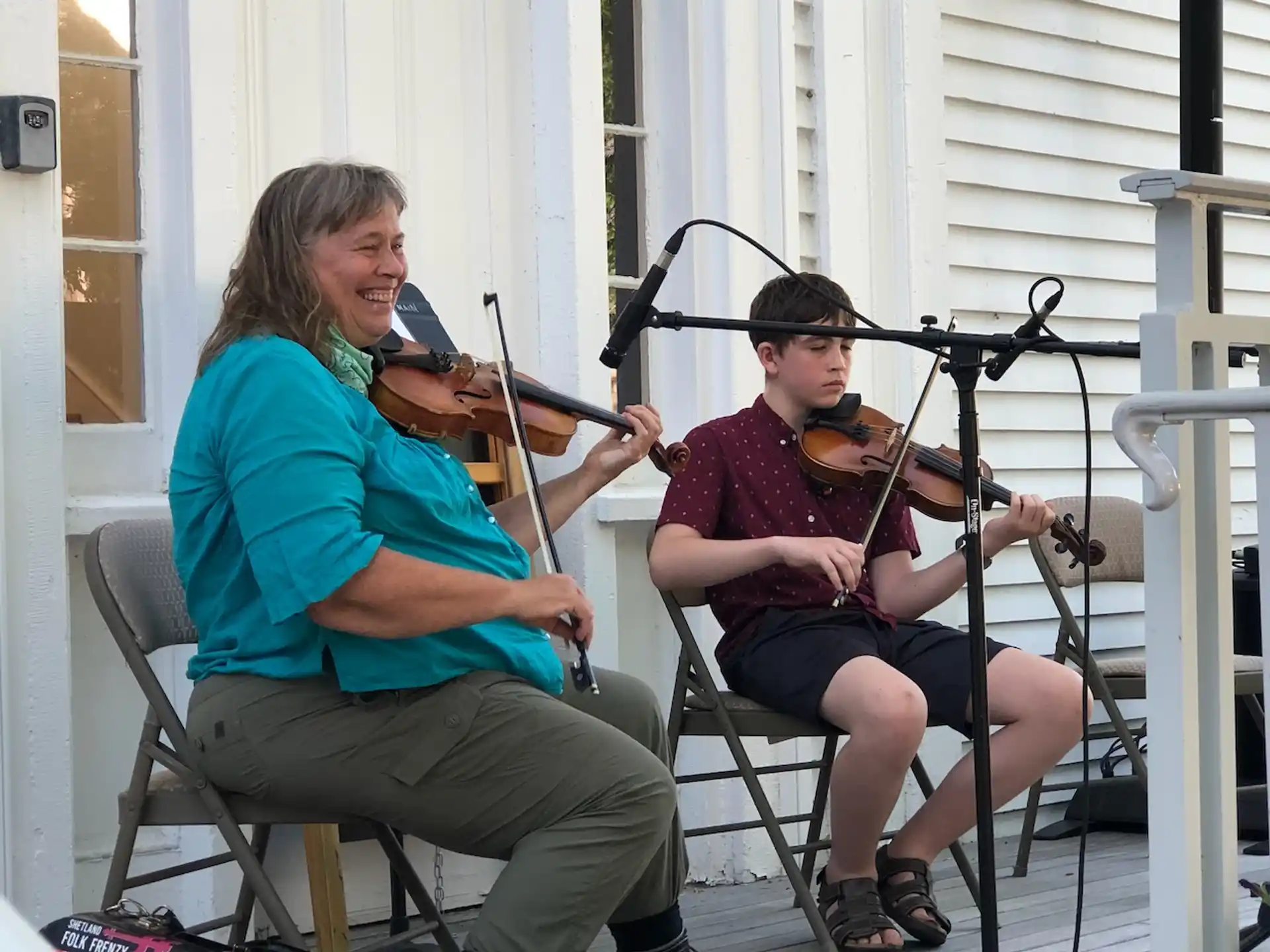 a man and a woman playing the violin