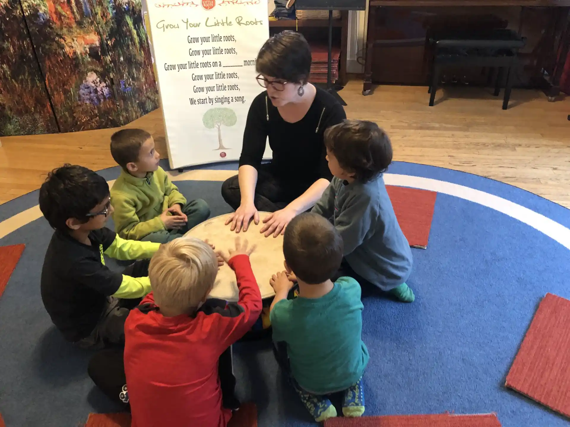 a person and several children sitting on the floor