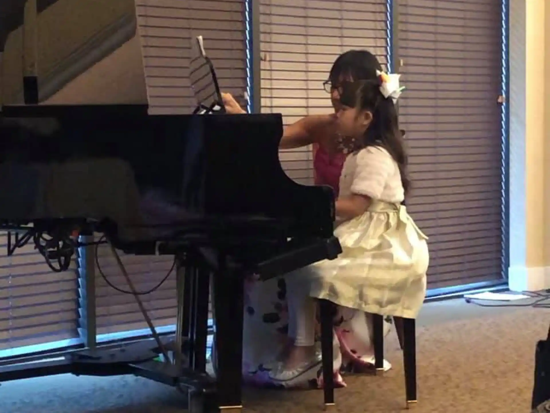 a girl playing a piano