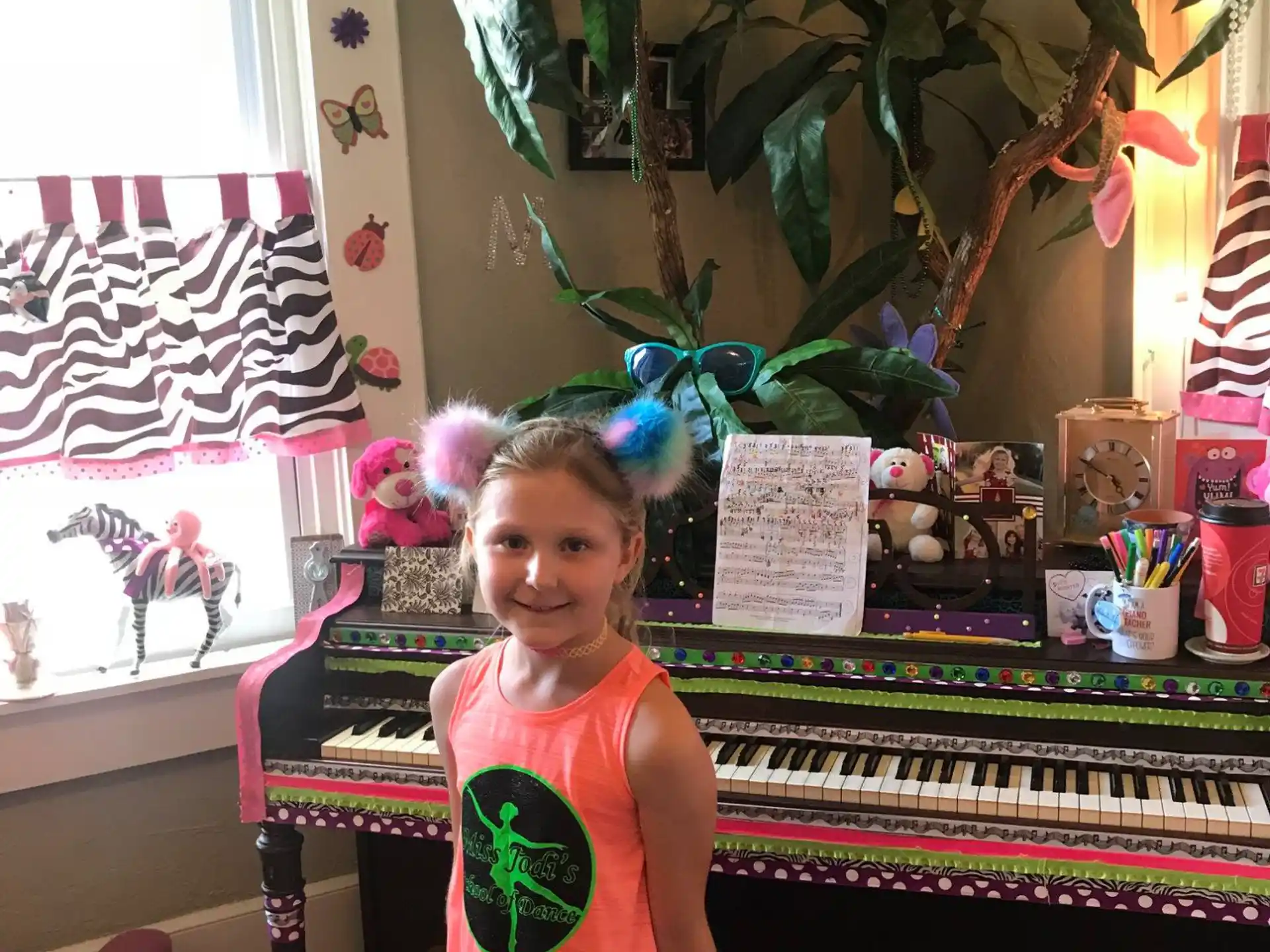 a girl standing next to a piano