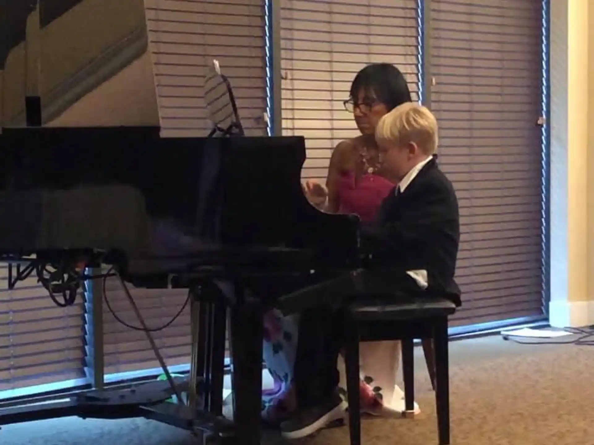 a person and a child playing piano